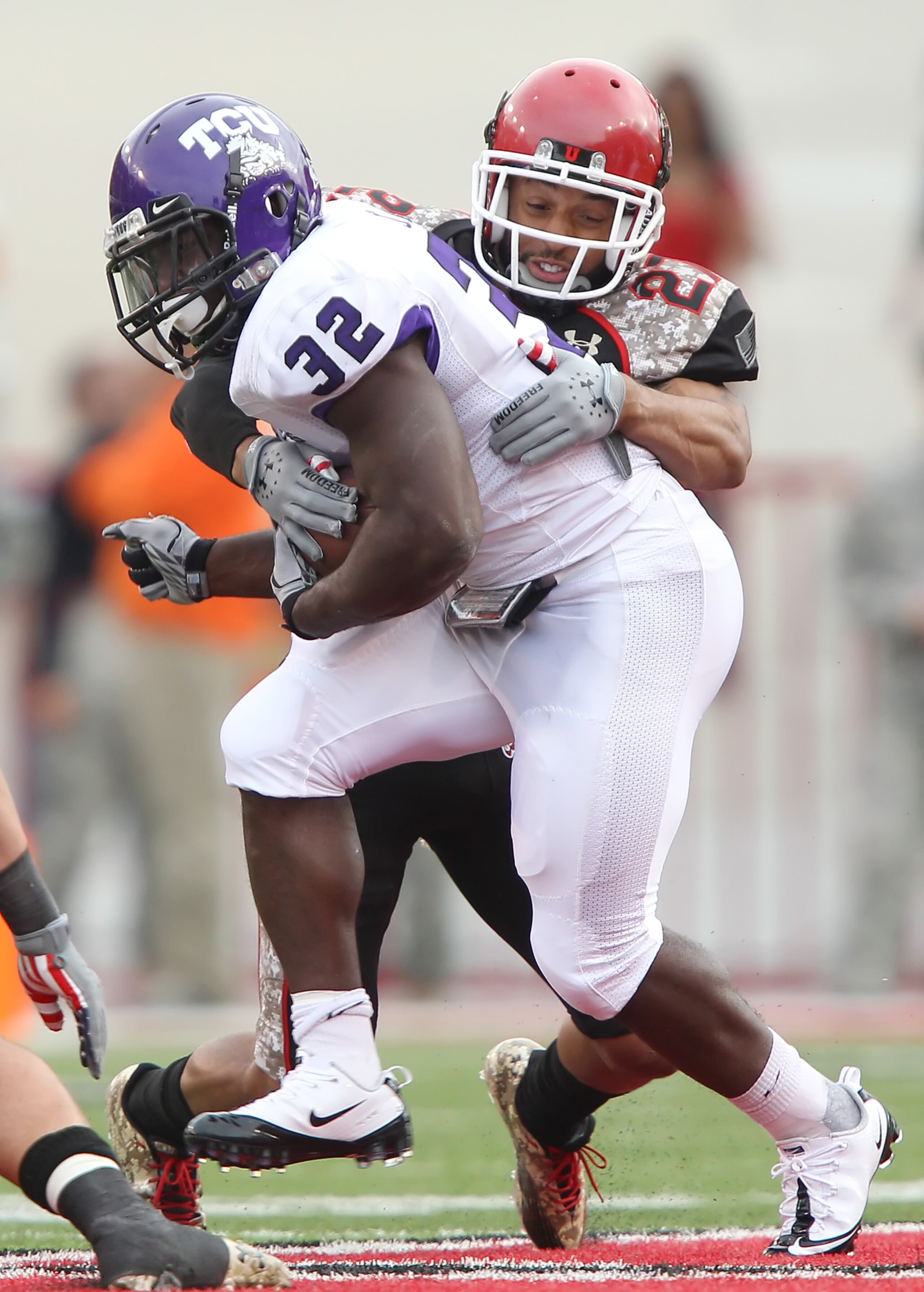 SALT LAKE CITY, UT - NOVEMBER 6: Waymon James #32 of the TCU Horned Frogs is hit by Brandon Burton #27 the Utah Utes during the second half of an NCAA Football game November 6, 2010 at Rice-Eccles Stadium in Salt Lake City, Utah. TCU Beat Utah 47-7.  (Pho