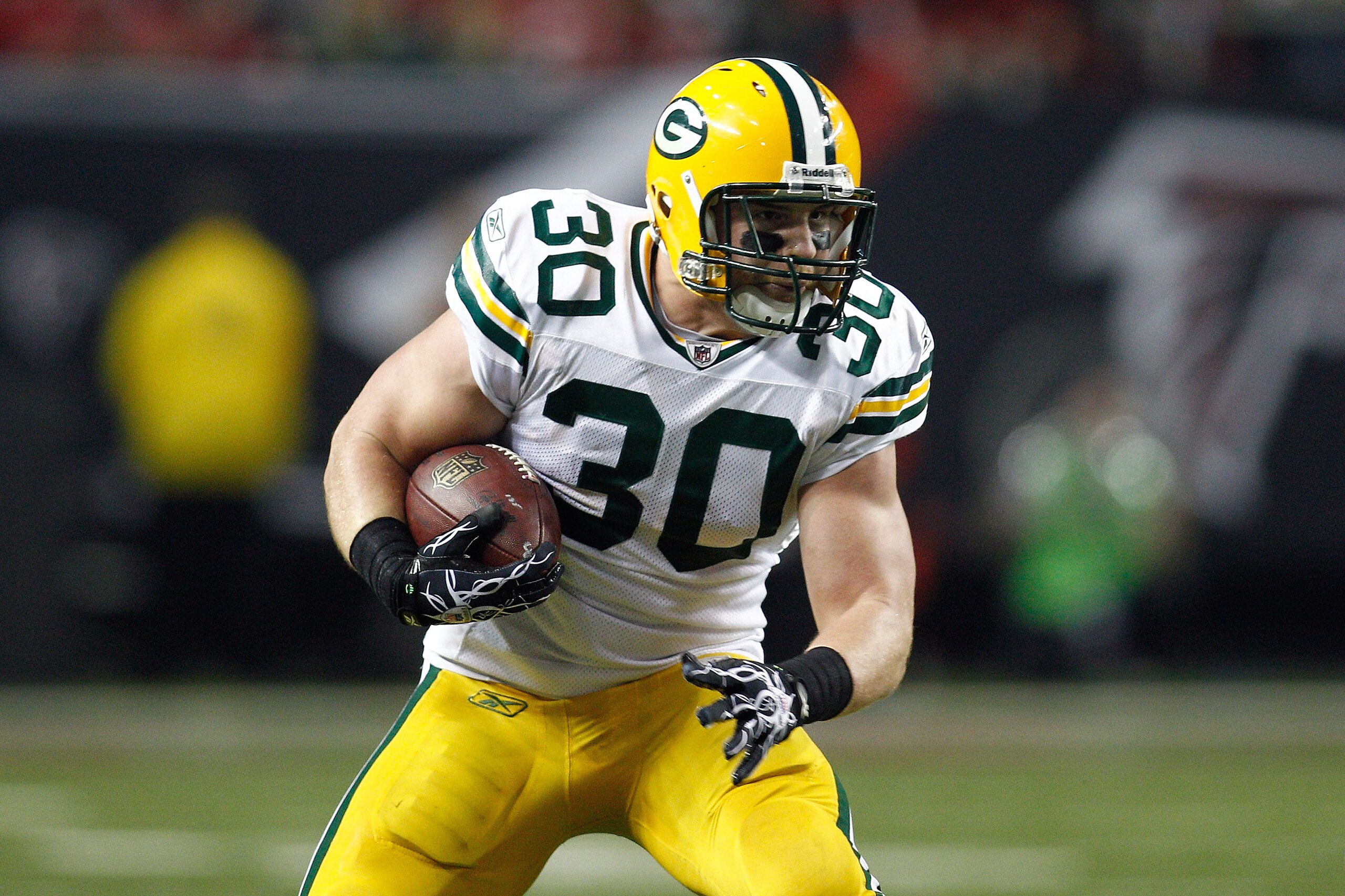 ATLANTA, GA - JANUARY 15:  John Kuhn #30 of the Green Bay Packers runs the ball against the Atlanta Falcons during their 2011 NFC divisional playoff game at Georgia Dome on January 15, 2011 in Atlanta, Georgia. The Packers won 48-21.  (Photo by Chris Gray