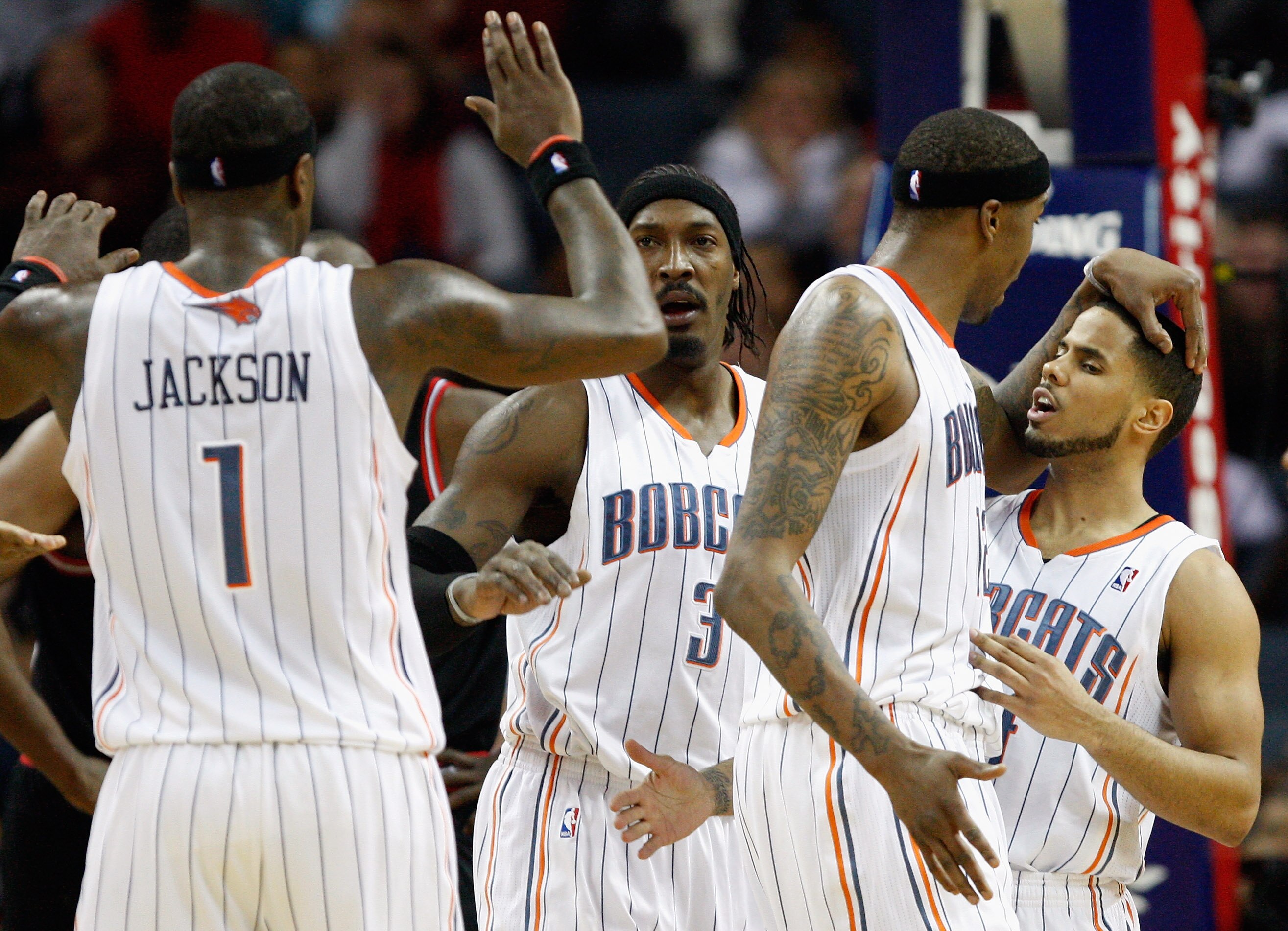 CHARLOTTE, NC - JANUARY 12:  Teammates Stephen Jackson #1 Gerald Wallace #3 Tyrus Thomas #12 and D.J. Augustin #14 of the Charlotte Bobcats celebrate after a basket against the Chicago Bulls during their game at Time Warner Cable Arena on January 12, 2011