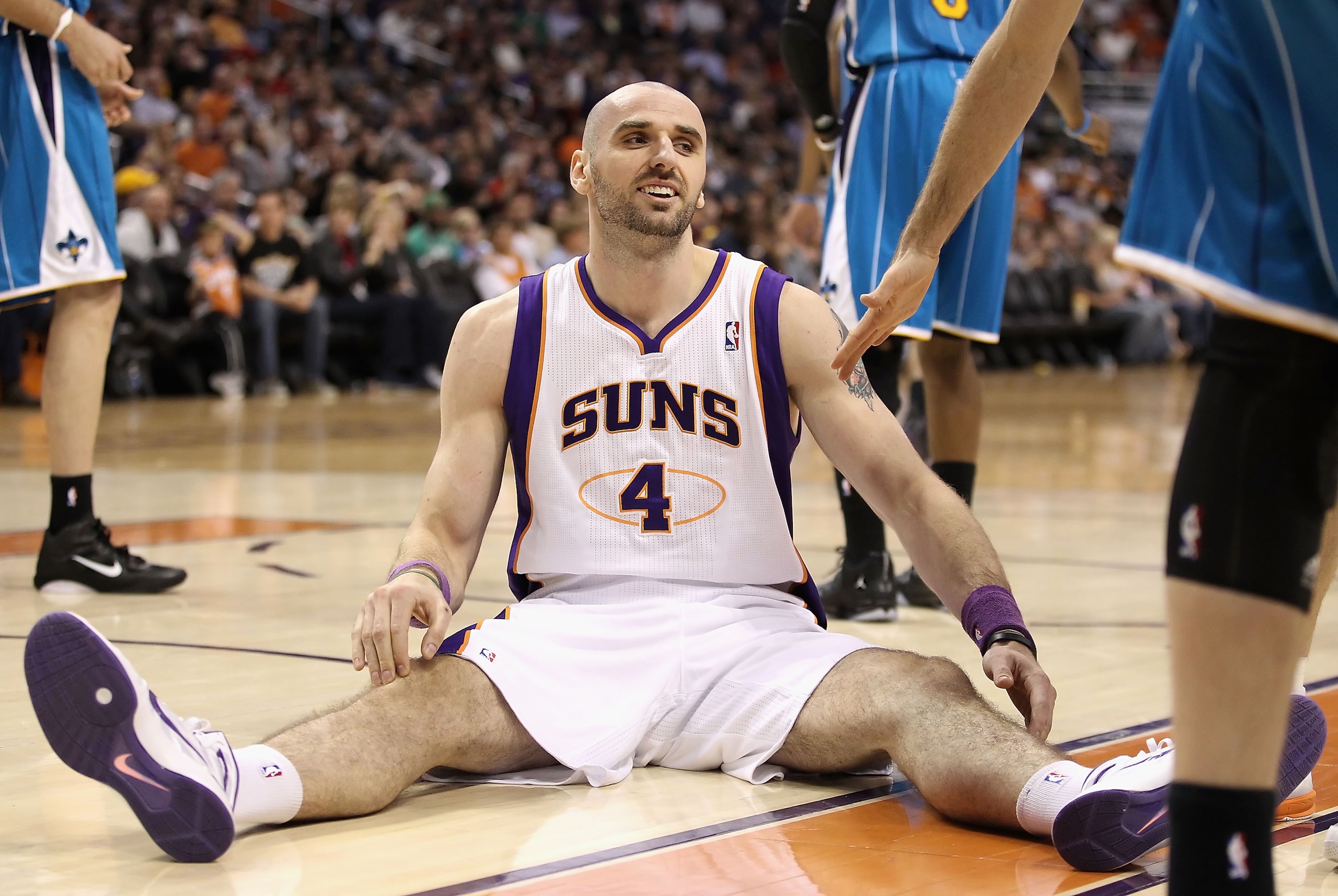 PHOENIX, AZ - JANUARY 30:  Marcin Gortat #4 of the Phoenix Suns reacts after falling to the court during the NBA game against the New Orleans Hornets at US Airways Center on January 30, 2011 in Phoenix, Arizona. The Suns defeated the Hornets 104-102.   NO
