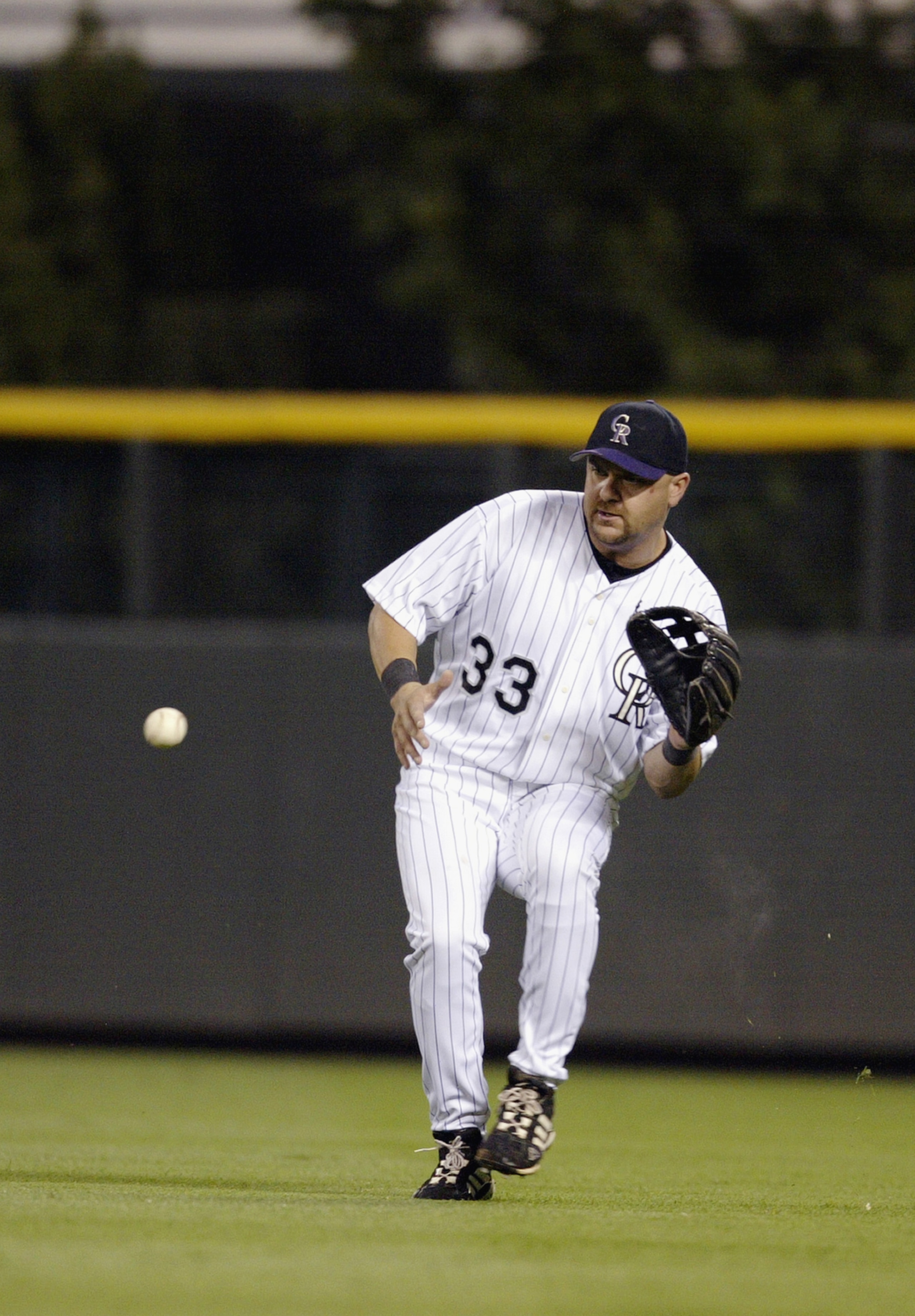 DENVER - AUGUST 27:  Right fielder Larry Walker #33 of the Colorado Rockies looks for the catch during the game against the San Francisco Giants at Coors Field on August 27, 2003  in Denver, Colorado.  The Giants won 6-4. (Photo by Brian Bahr/Getty Images