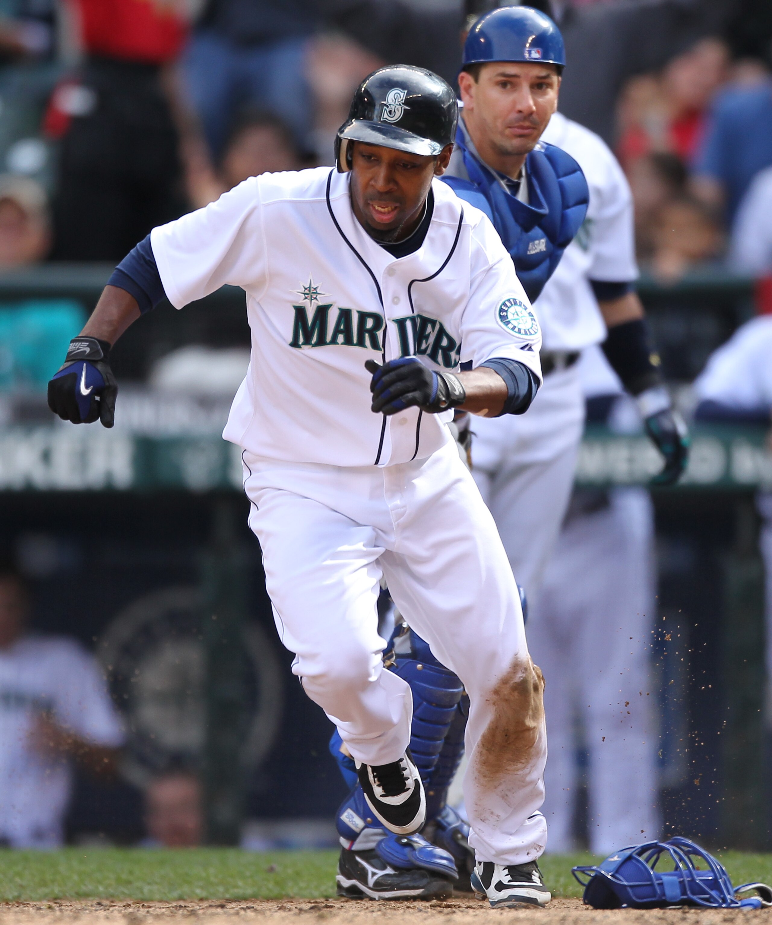 SEATTLE - SEPTEMBER 19:  Chone Figgins #9 of the Seattle Mariners runs back to touch home plate after missing it on his initial slide against catcher Matt Treanor #20 of the Texas Rangers on a double by Franklin Gutierrez #21 in the sixth inning at Safeco