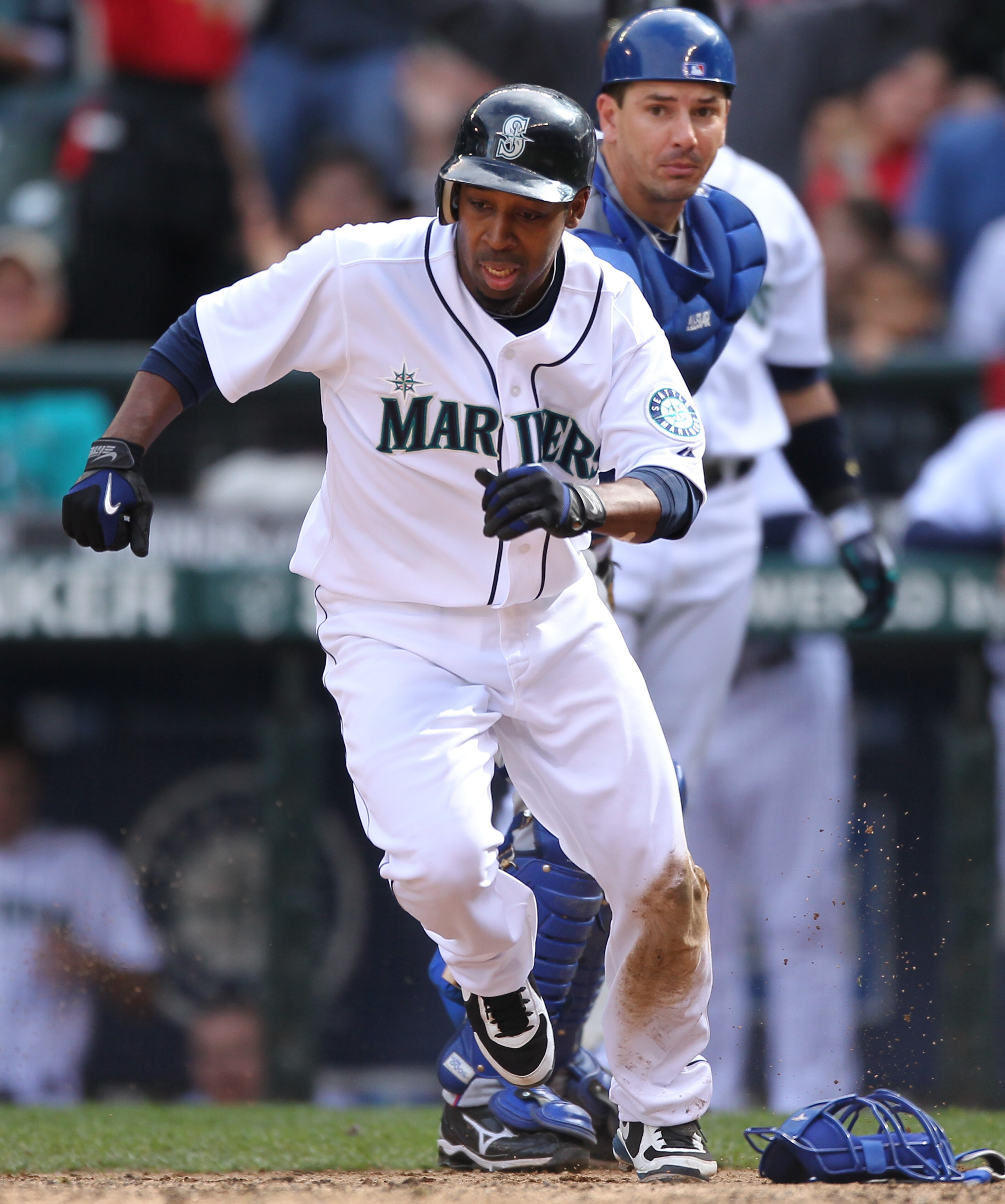 SEATTLE - SEPTEMBER 19:  Chone Figgins #9 of the Seattle Mariners runs back to touch home plate after missing it on his initial slide against catcher Matt Treanor #20 of the Texas Rangers on a double by Franklin Gutierrez #21 in the sixth inning at Safeco