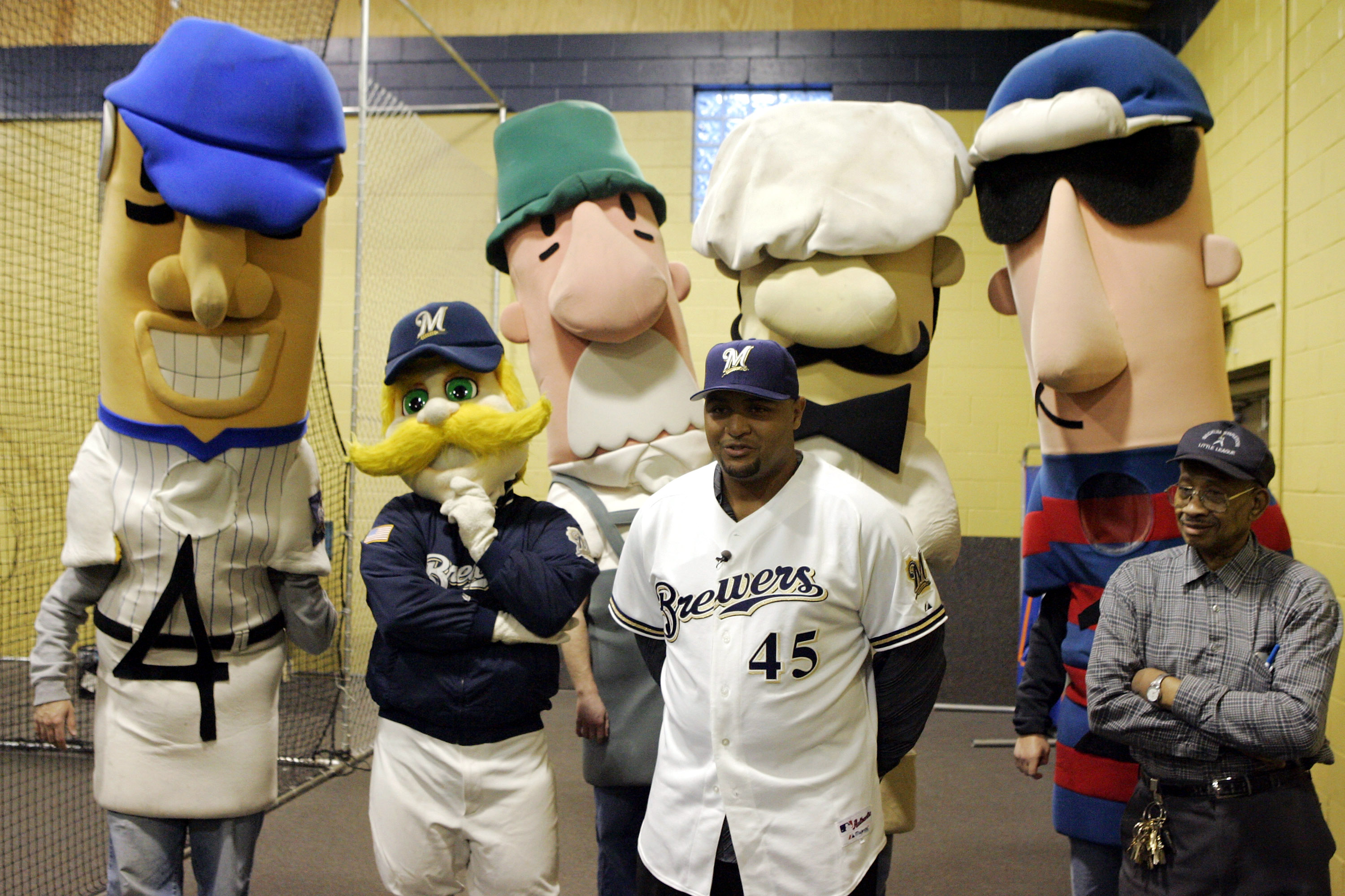 MILWAUKEE - JANUARY 10:  Carlos Lee, newly introduced as #45 of the Milwaukee Brewers, speaks to inner-city little league kids with the Brewer mascots behind him on January 10, 2005 at Beckum Stapleton Field in Milwaukee, Wisconsin.  (Photo by Brian Bahr/