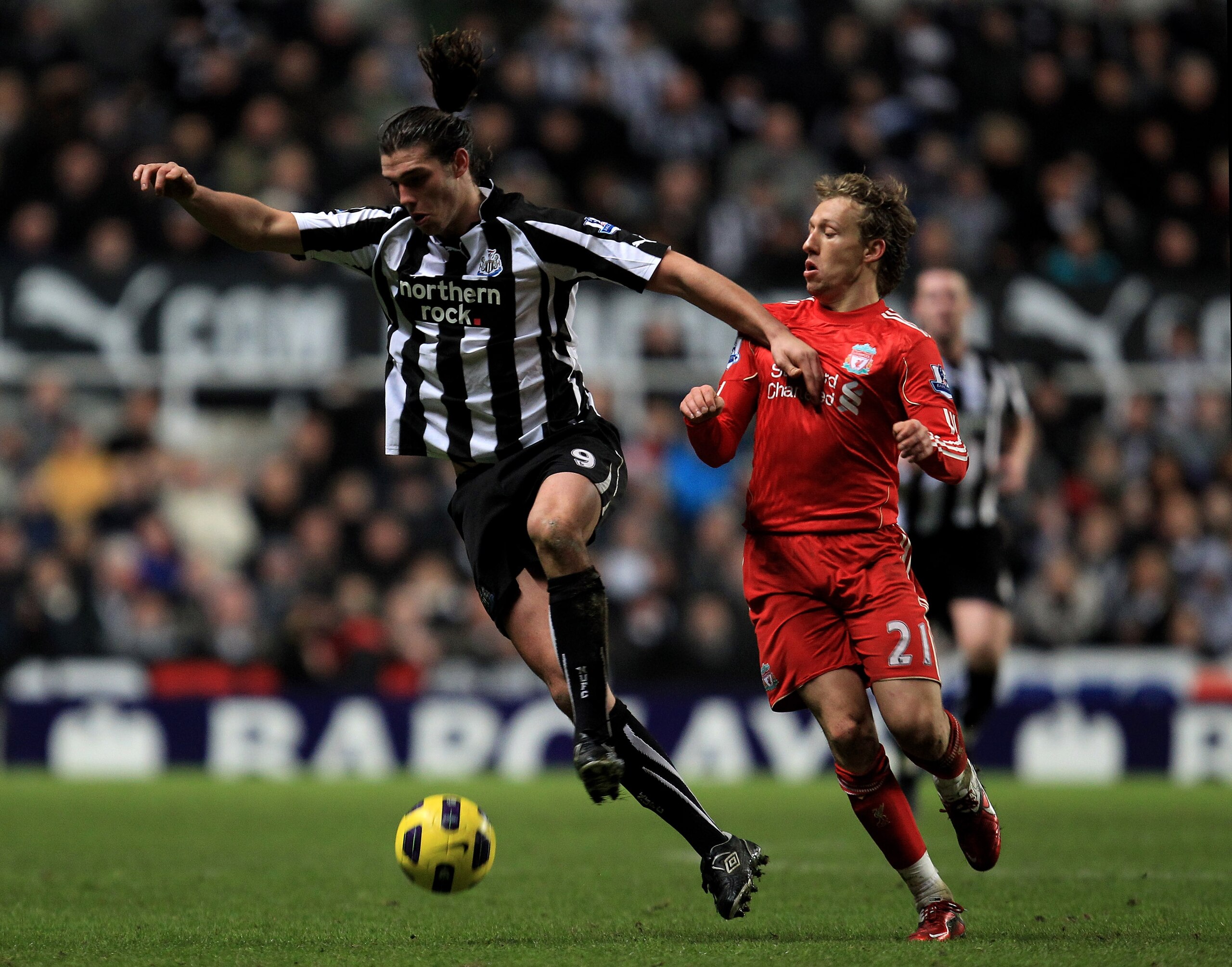 NEWCASTLE UPON TYNE, ENGLAND - DECEMBER 11: Andy Carroll of Newcastle United competes with Lucas of Liverpool during the Barclays Premier League match between Newcastle United and Liverpool at St James' Park on December 11, 2010 in Newcastle, England. ( NEWCASTLE UPON TYNE, ENGLAND - DECEMBER 11: Andy Carroll of Newcastle United competes with Lucas of Liverpool during the Barclays Premier League match between Newcastle United and Liverpool at St James' Park on December 11, 2010 in Newcastle, England. (