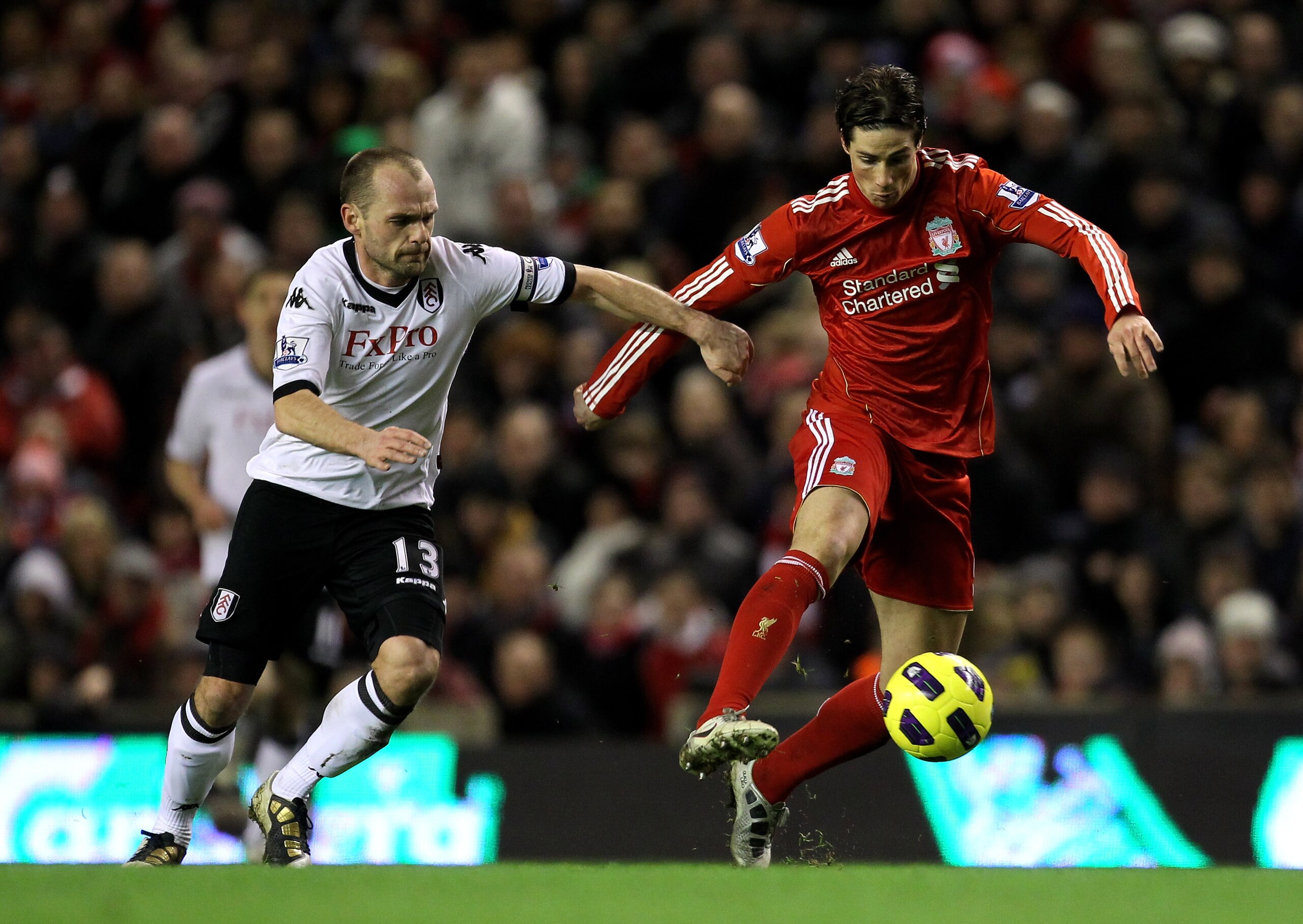 LIVERPOOL, ENGLAND - JANUARY 26: Fernando Torres of Liverpool competes with Danny Murphy of Fulham during the Barclays Premier League match between Liverpool and Fulham at Anfield on January 26, 2011 in Liverpool, England. (Photo by Alex Livesey/Getty I LIVERPOOL, ENGLAND - JANUARY 26: Fernando Torres of Liverpool competes with Danny Murphy of Fulham during the Barclays Premier League match between Liverpool and Fulham at Anfield on January 26, 2011 in Liverpool, England. (Photo by Alex Livesey/Getty I