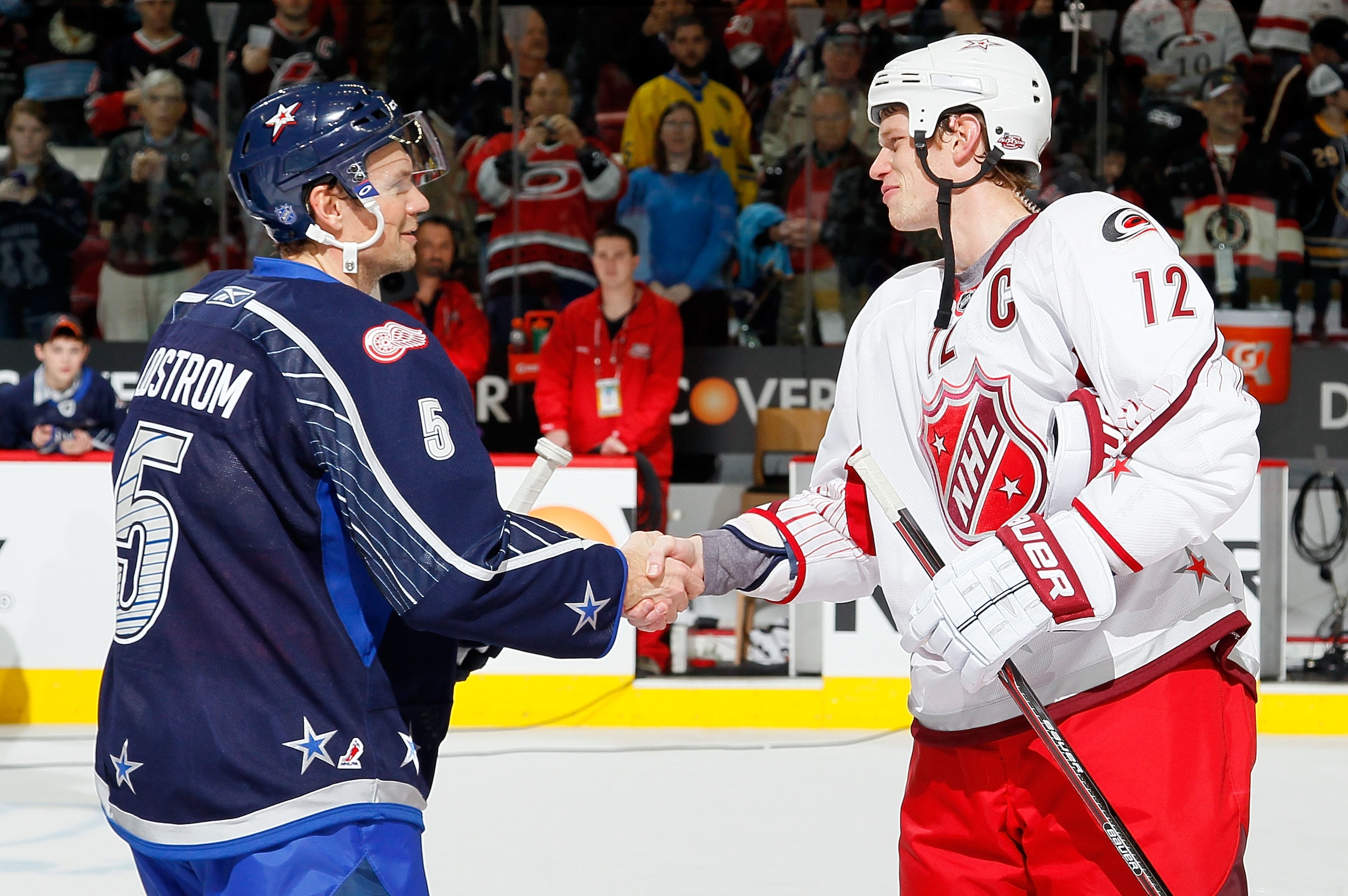 RALEIGH, NC - JANUARY 30:  Team Lidstrom captain Nicklas Lidstrom #5 of the Detroit Red Wings shakes hands with Team Staal captain Eric Staal #12 of the Carolina Hurricanes after Team Lidstrom defeated Team Staal 11 to 10 in the 58th NHL All-Star Game at