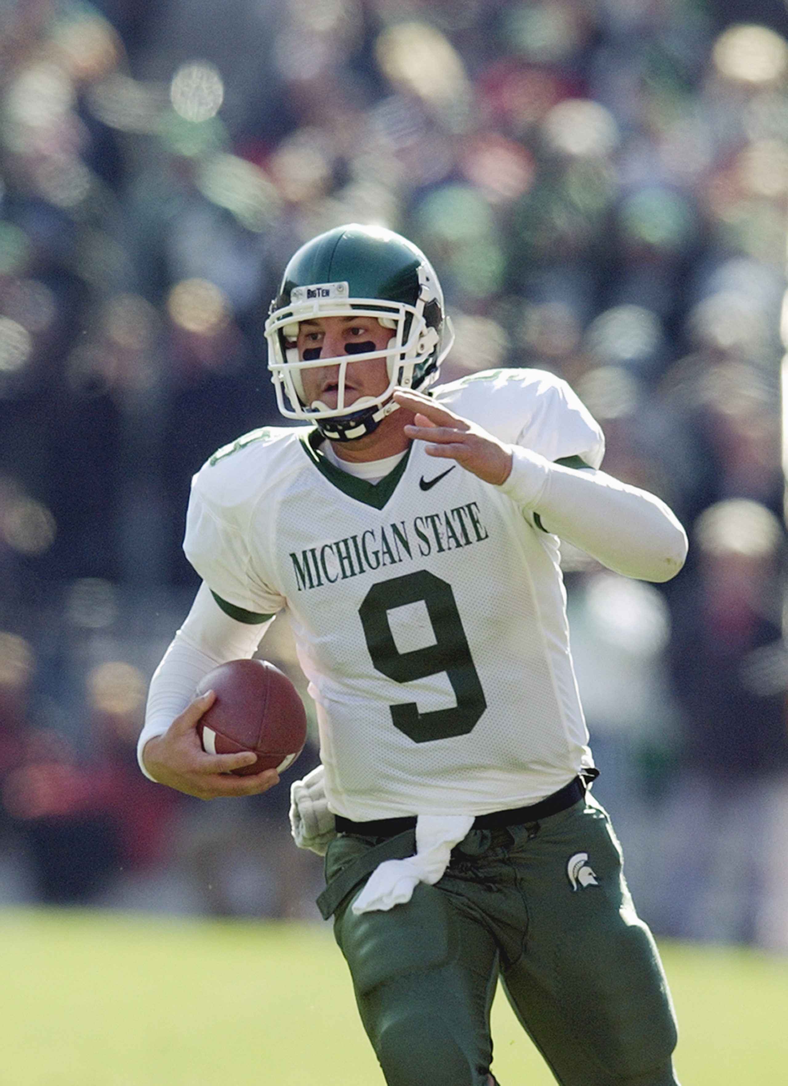 COLUMBUS, OH - NOVEMBER 8:  Quarterback Jeff Smoker #9 of the Michigan State University Spartans scrambles with the ball against the Ohio State University Buckeyes during the game at Ohio Stadium on November 8, 2003 in Columbus, Ohio. Ohio State defeated
