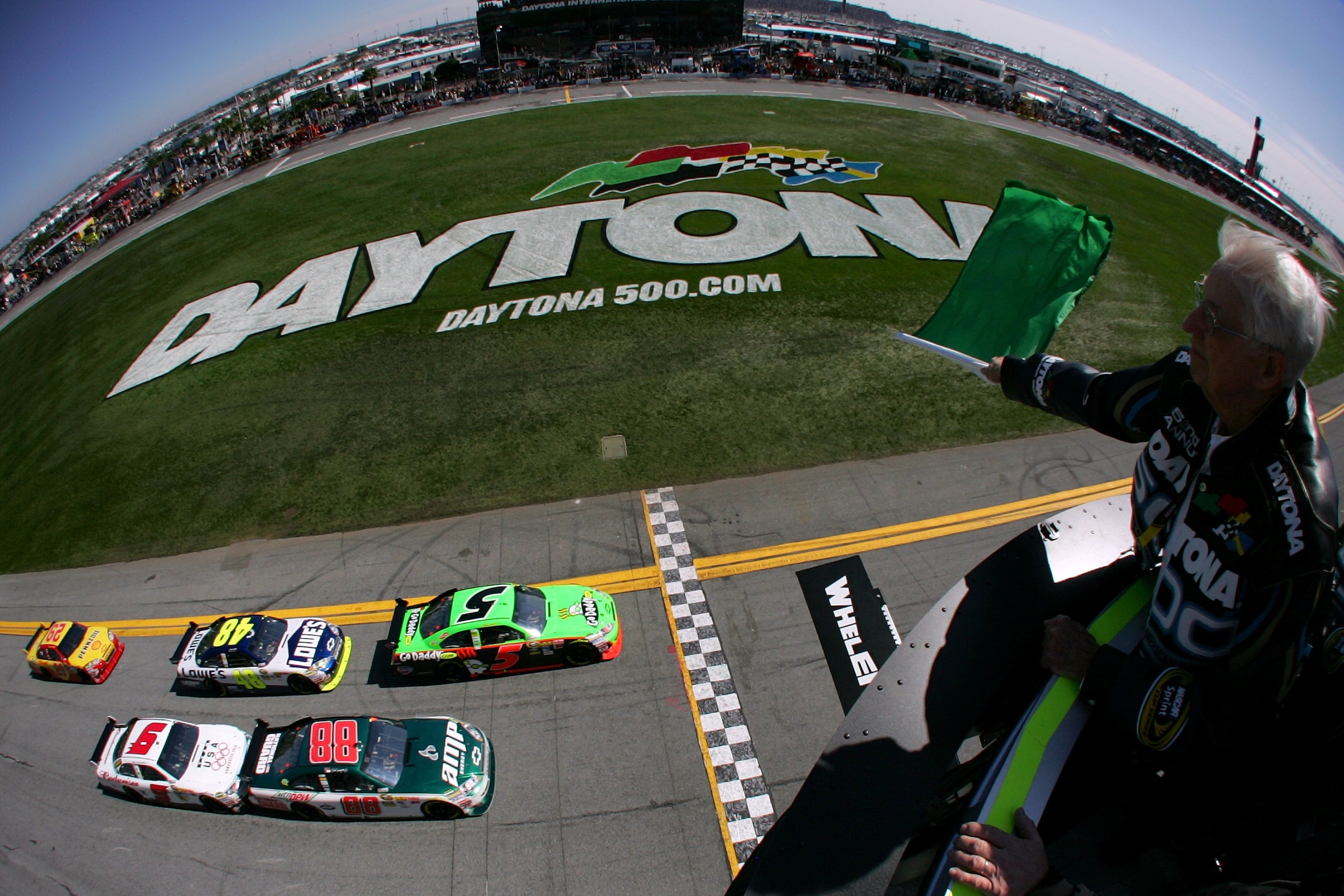 DAYTONA BEACH, FL - FEBRUARY 14:  (EDITORS NOTE: RETRANSMITTED WITH AN ALTERNATE CROP) NASCAR legend Glenn Wood waves the green flag as Mark Martin, driver of the #5 GoDaddy.com Chevrolet, leads the field to start the NASCAR Sprint Cup Series Daytona 500