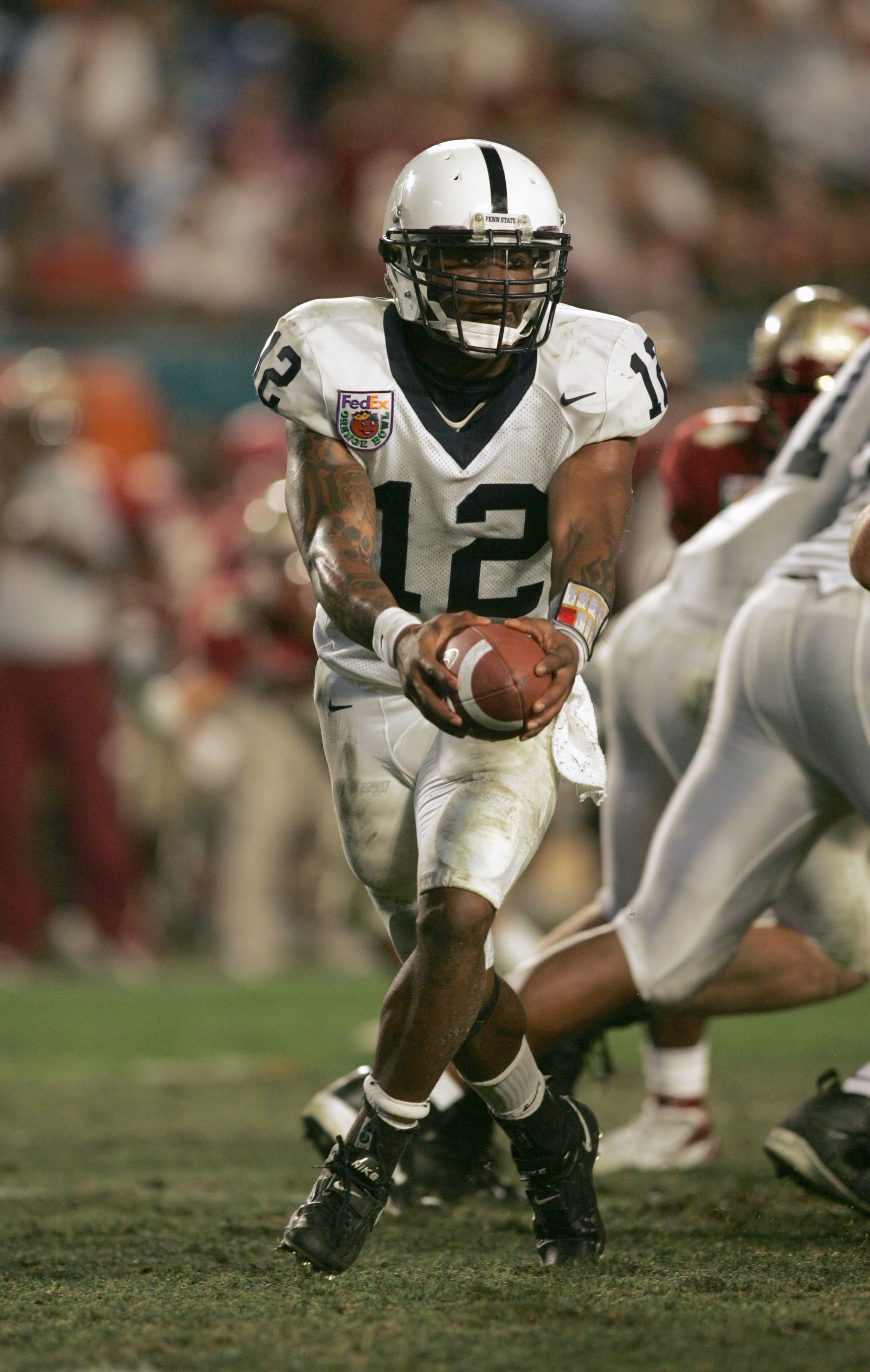 MIAMI GARDENS, FL - JANUARY 3:  Quarterback Michael Robinson# 12 of the Penn State Nittany Lions looks to hand off the ball during the 72nd Fed Ex Orange Bowl against the Florida State Seminoles at Dolphins Stadium on January 3, 2005 in Miami Gardens, Flo