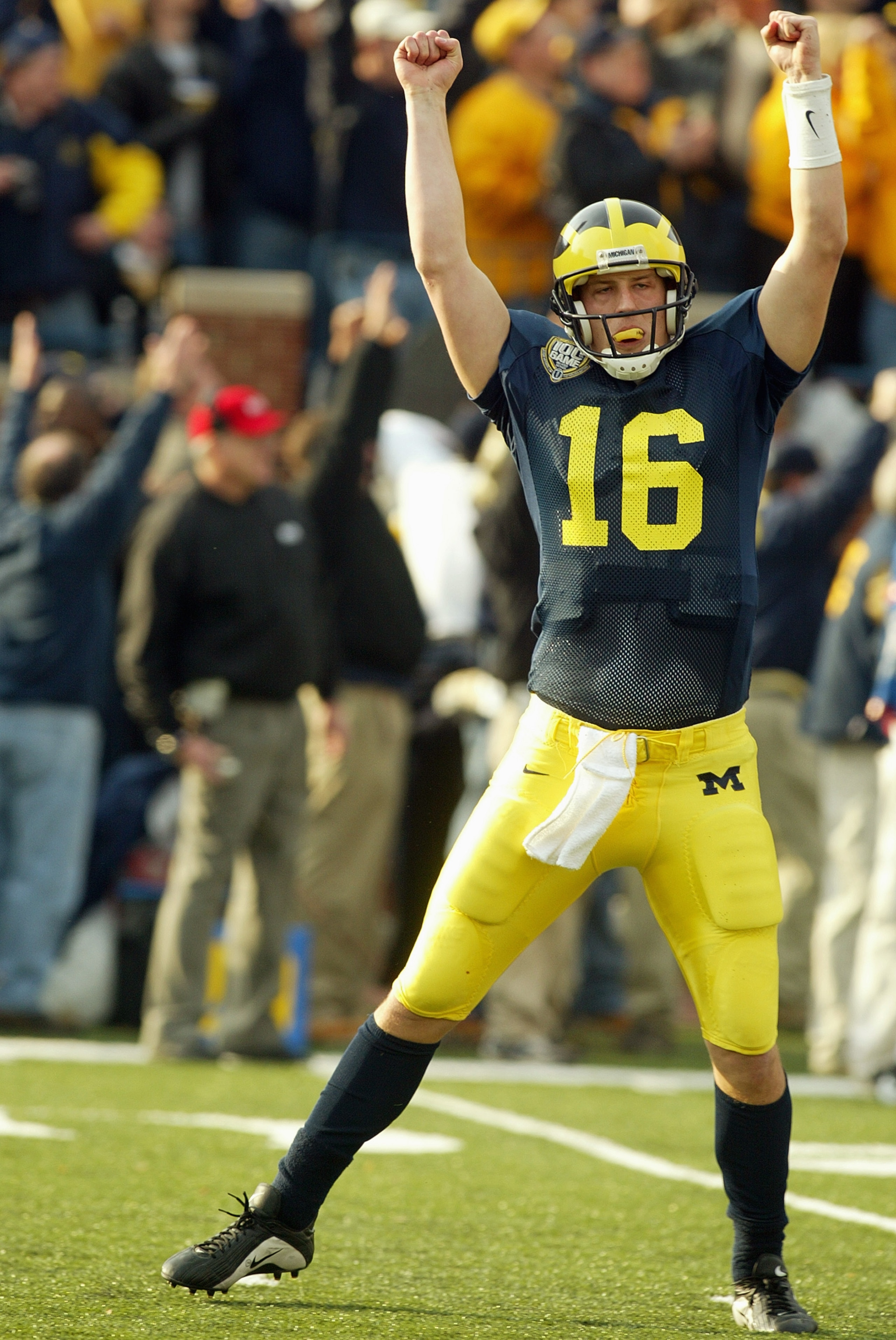 ANN ARBOR, MI - NOVEMBER 22:  Quarterrback John Navarre #16 of the Michigan Wolverines celebrates on the field during the game against the Ohio State Buckeyes during the 100th meeting of the two teams November 22, 2003 at Michigan Stadium in Ann Arbor, Mi