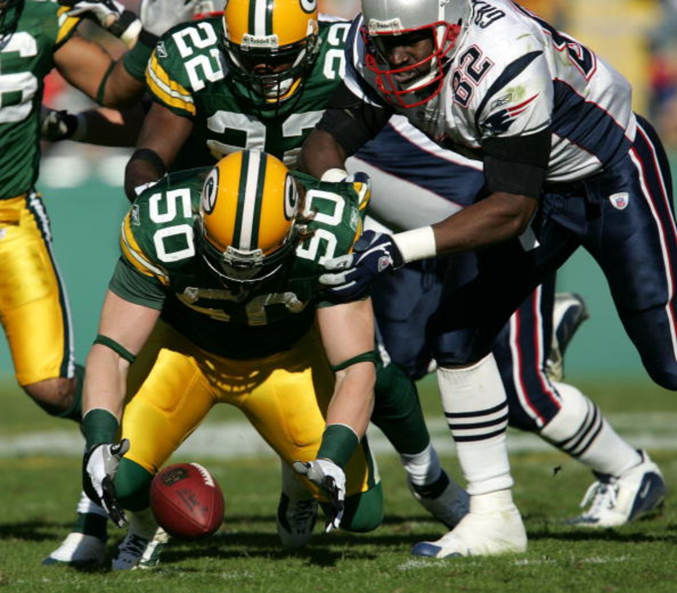 GREEN BAY, WI - NOVEMBER 19:  A.J. Hawk #50 of the Green Bay Packers drops to recover a fumble as teammate Marquand Manuel #22 and Daniel Graham #82 of the New England Patriots chases down the play on November 19, 2006 at Lambeau Field in Green Bay, Wisco