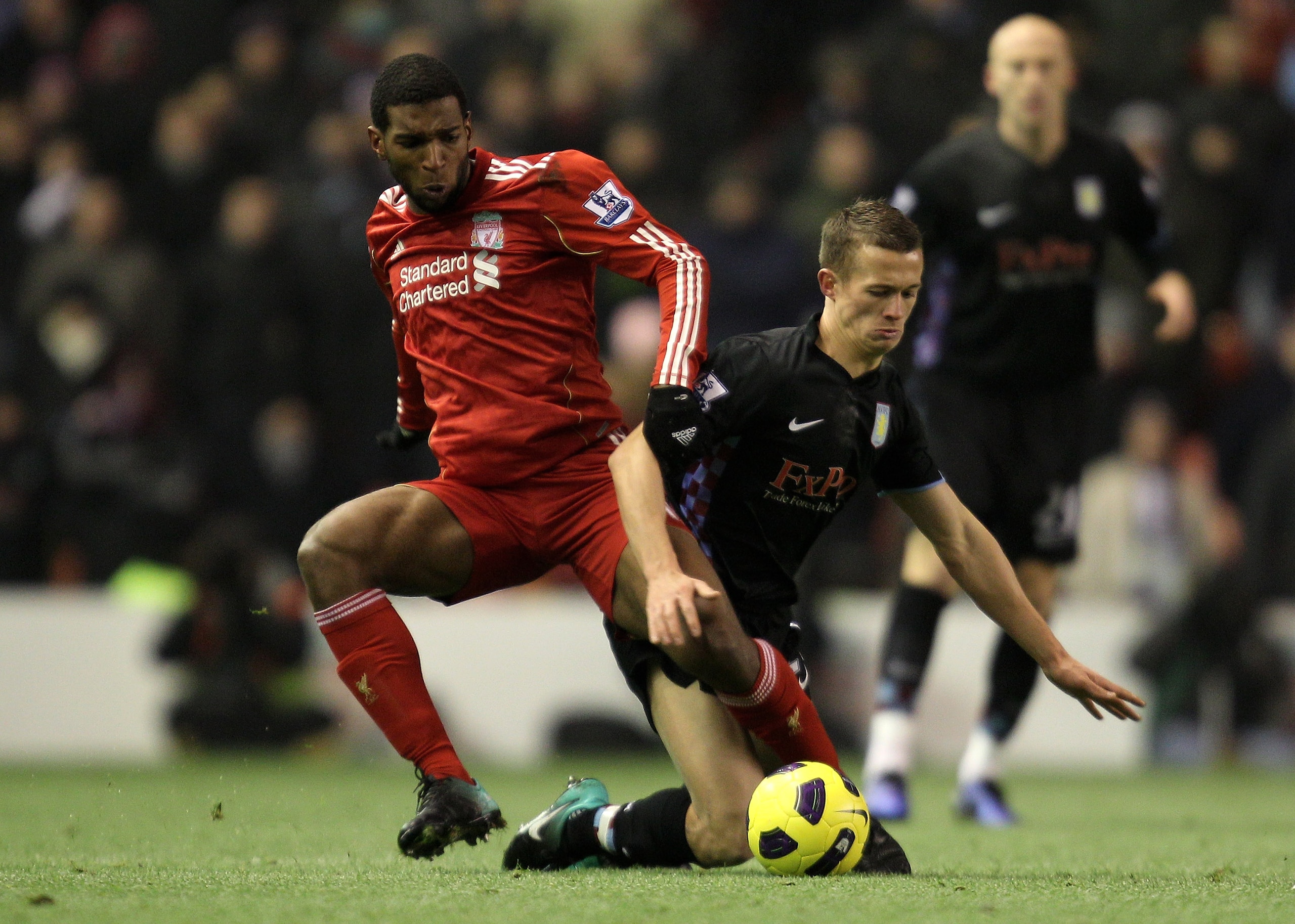 LIVERPOOL, ENGLAND - DECEMBER 06:  Ryan Babel of Liverpool tangles with Jonathan Hogg of Aston Villa during the Barclays Premier League match between Liverpool and Aston Villa at Anfield on December 6, 2010 in Liverpool, England.  (Photo by Mark Thompson/