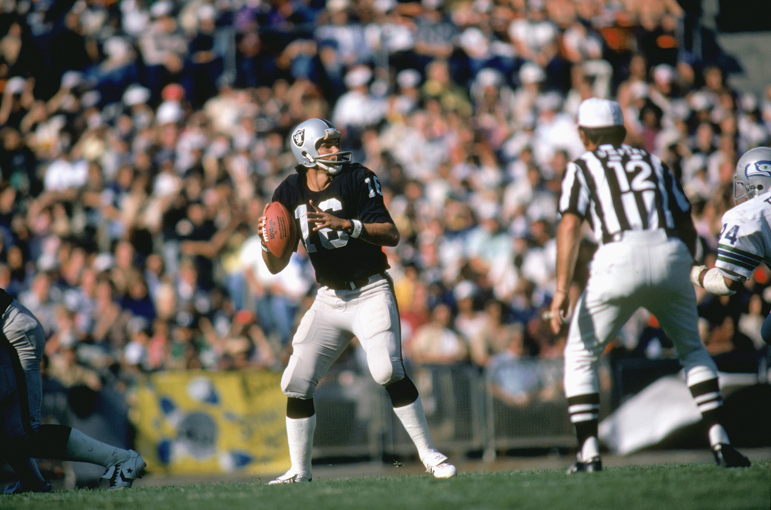 LOS ANGELES, CA - UNDATED: Quarterback Jim Plunkett #16 of the Los Angeles Raiders falls back to pass during a NFL game against the Seattle Seahawks at Los Angeles Coliseum in Los Angeles, California. Jim Plunkett played for the Los Angeles Raiders from LOS ANGELES, CA - UNDATED: Quarterback Jim Plunkett #16 of the Los Angeles Raiders falls back to pass during a NFL game against the Seattle Seahawks at Los Angeles Coliseum in Los Angeles, California. Jim Plunkett played for the Los Angeles Raiders from