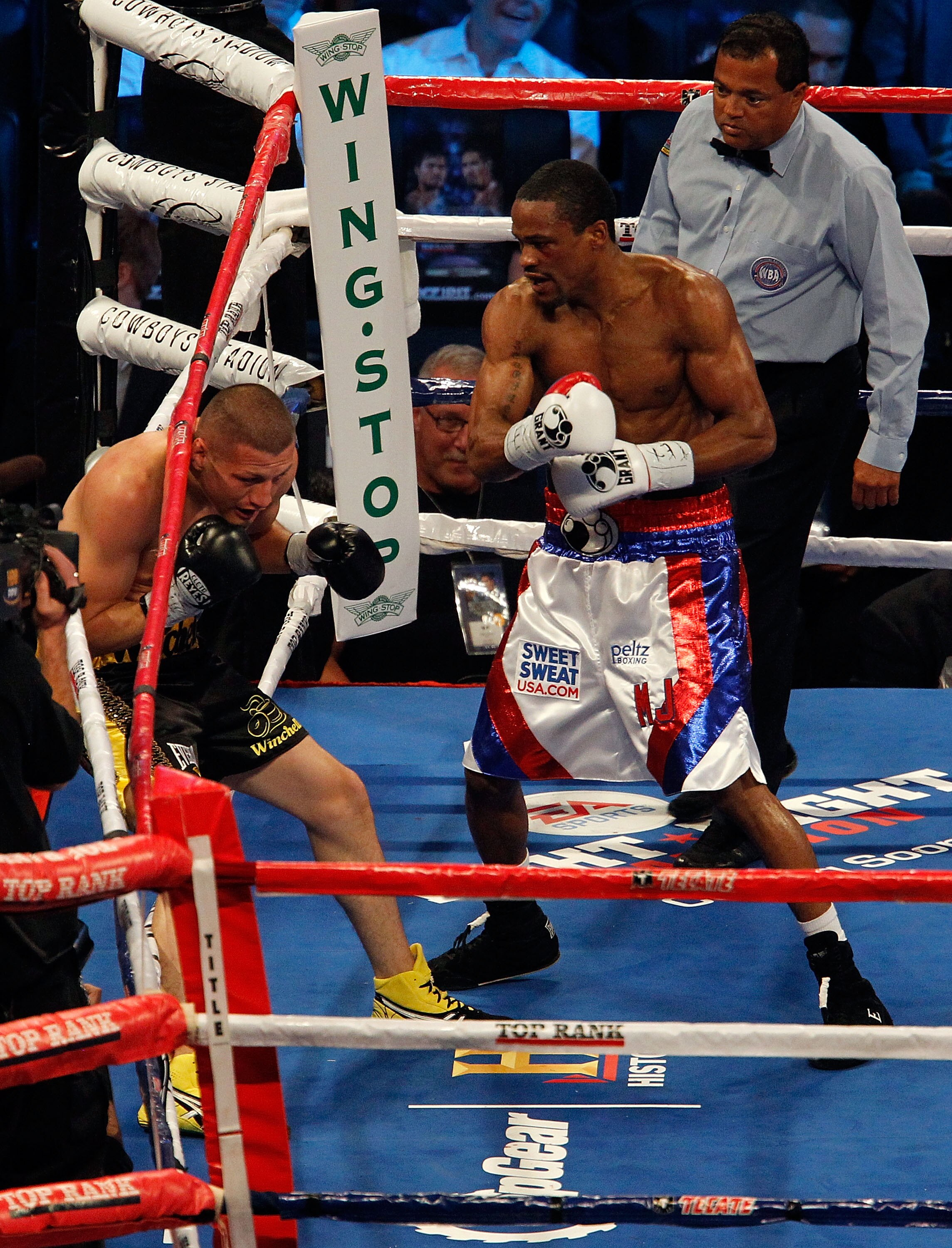ARLINGTON, TX - NOVEMBER 13:  Mike Jones (red white and blue trunks) backs Jesus Soto-Karass of Mexico (black trunks) into the ropes during their NABA NABO WBC Continental Americas Welterweight Title bout at Cowboys Stadium on November 13, 2010 in Arlingt