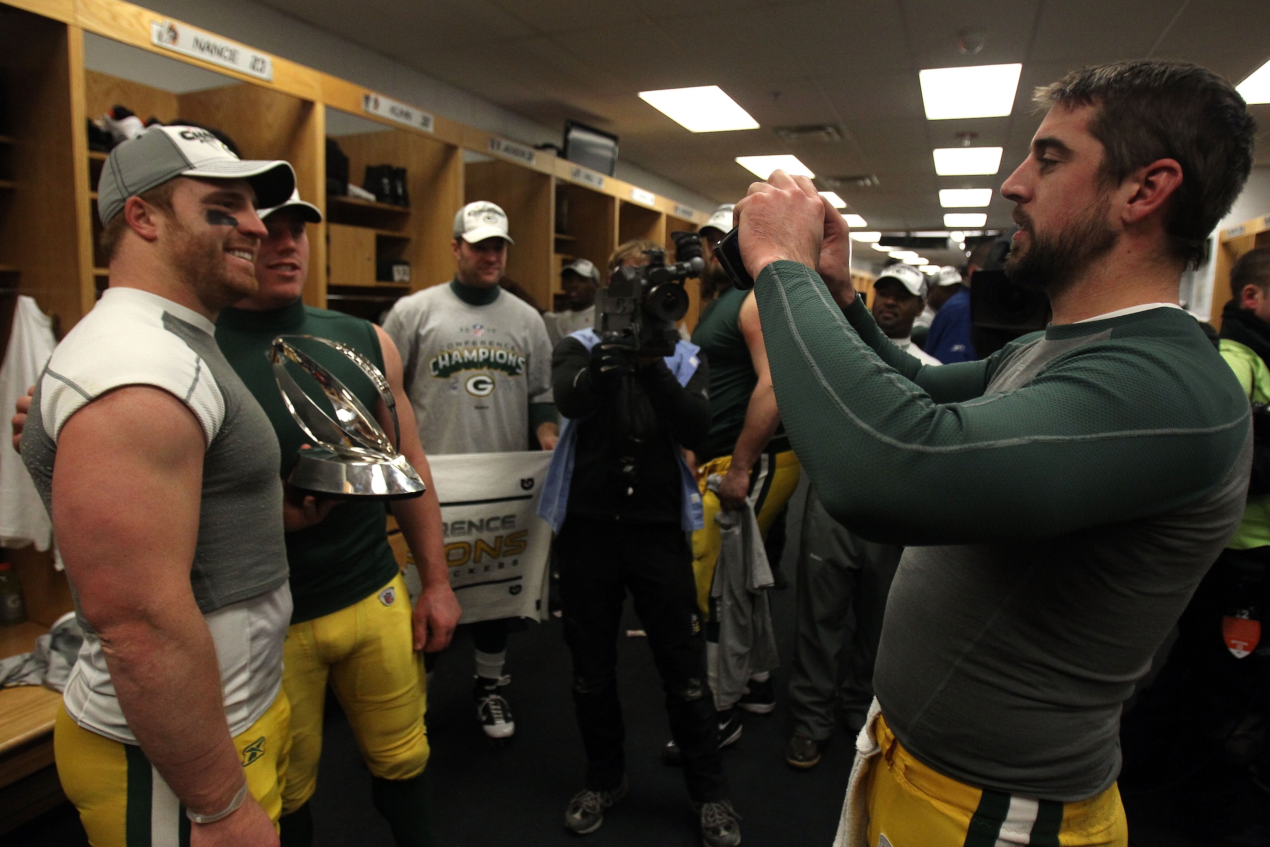 CHICAGO, IL - JANUARY 23:  John Kuhn #30 and Matt Flynn #10 of the Green Bay Packers pose for a picture taken by Aaron Rodgers #12 as they celebrate the Packers 21-14 victory against the Chicago Bears after the NFC Championship Game at Soldier Field on Ja