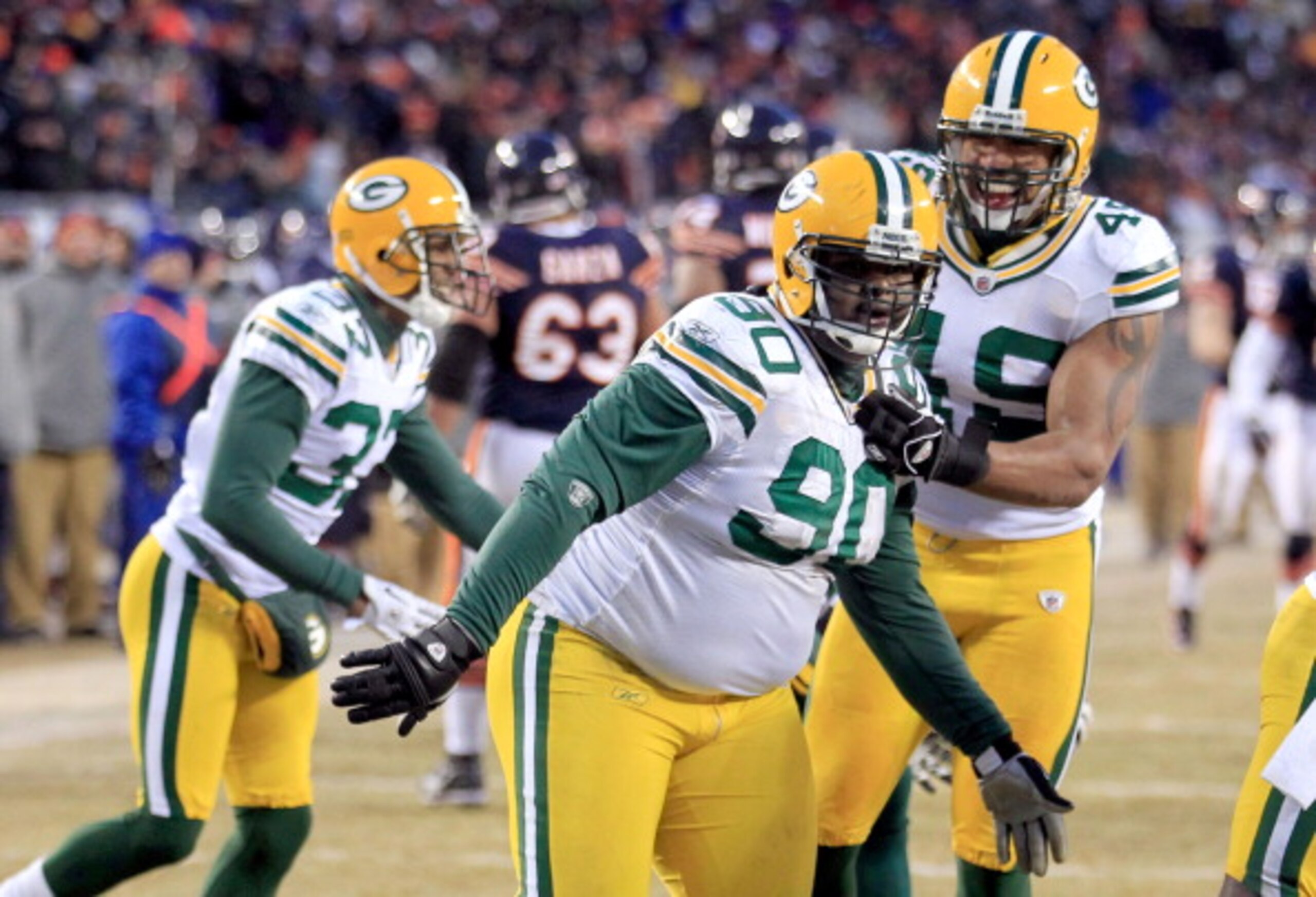 CHICAGO, IL - JANUARY 23:  B.J. Raji #90 of the Green Bay Packers reacts with teammates after scoring on a 18-yard interception return for a touchdown in the fourth quarter against the Chicago Bears in the NFC Championship Game at Soldier Field on January
