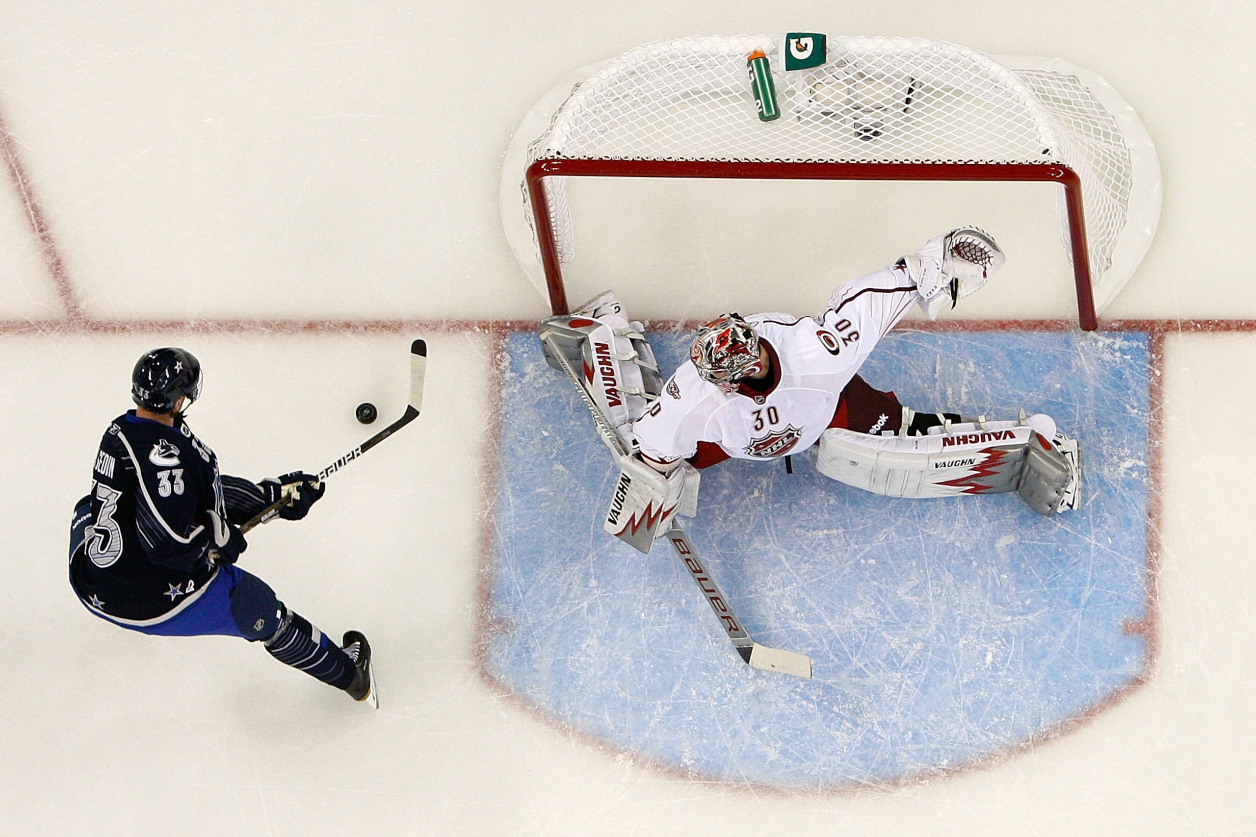 RALEIGH, NC - JANUARY 30:  Henrik Sedin #33 of the Vancouver Canucks attempts to score a goal against Cam Ward #30 of the Carolina Hurricanes in the 58th NHL All-Star Game at RBC Center on January 30, 2011 in Raleigh, North Carolina.  (Photo by Kevin C. C
