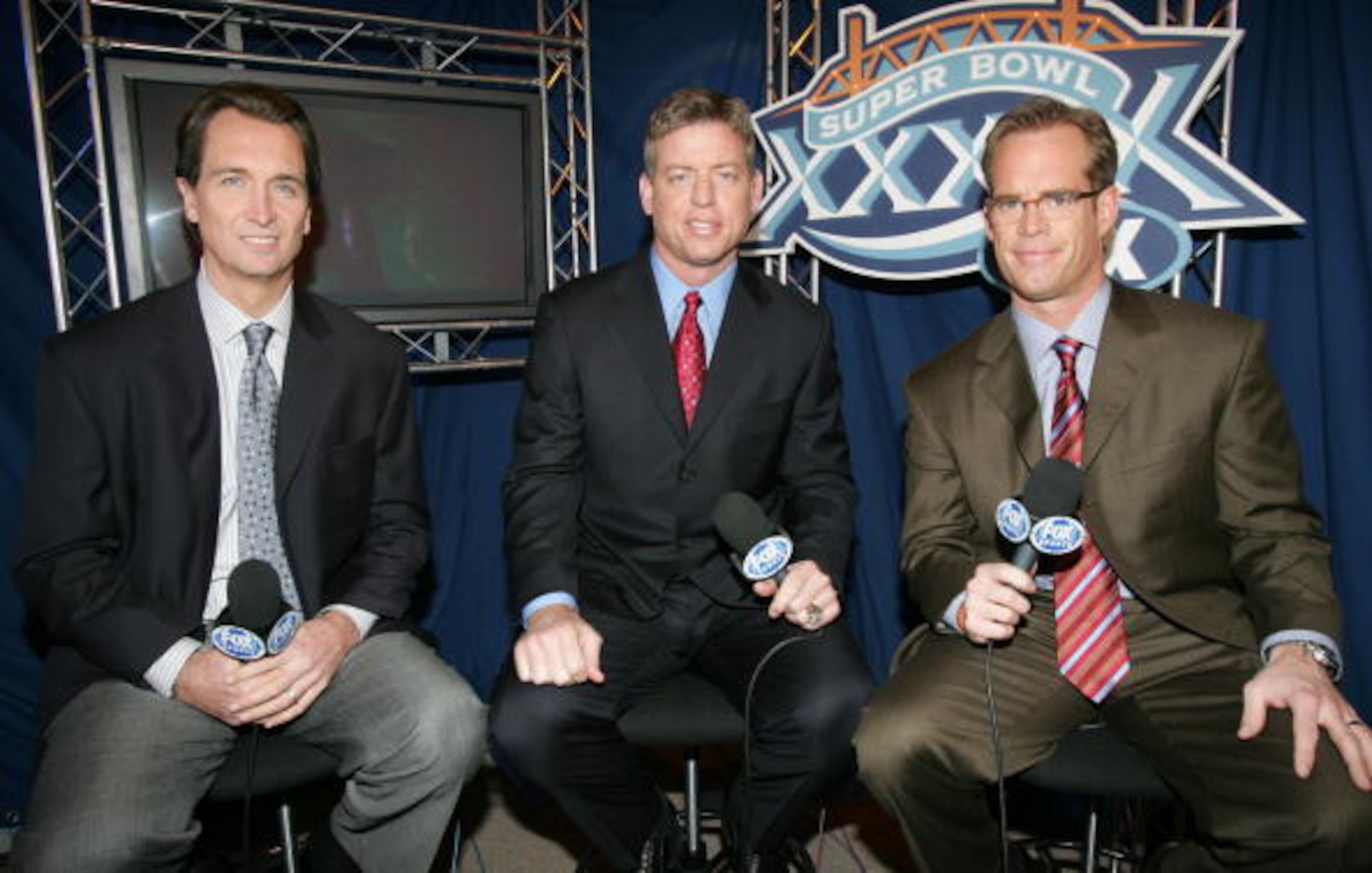 JACKSONVILLE, FL - FEBRUARY 06:  (L-R) FOX game broadcasters Cris Collinsworth, Troy Aiken and Joe Buck during the XXXIX Superbowl pregame show at Alltel Stadium on February 6, 2005 in Jacksonville, Florida.  (Photo by Frank Micelotta/Getty Images)