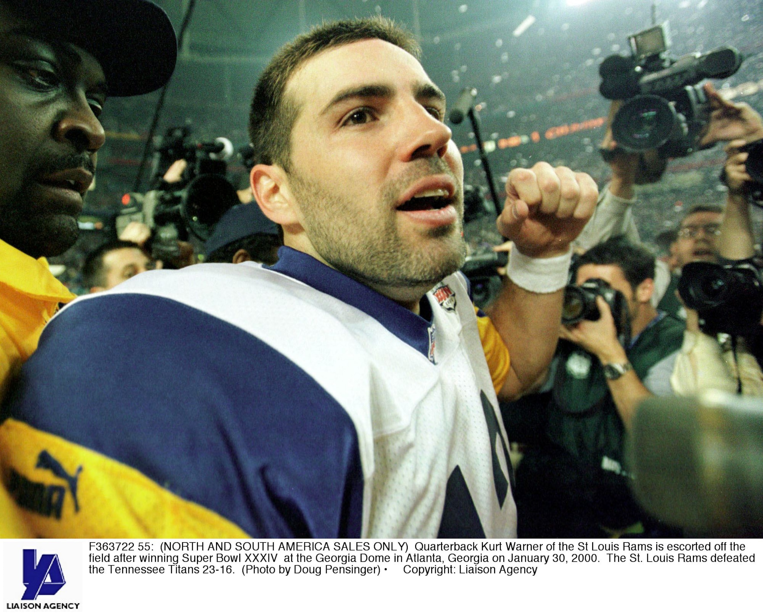 F363722 55: (NORTH AND SOUTH AMERICA SALES ONLY) Quarterback Kurt Warner of the St Louis Rams is escorted off the field after winning Super Bowl XXXIV at the Georgia Dome in Atlanta, Georgia on January 30, 2000. The St. Louis Rams defeated the Tennessee T F363722 55: (NORTH AND SOUTH AMERICA SALES ONLY) Quarterback Kurt Warner of the St Louis Rams is escorted off the field after winning Super Bowl XXXIV at the Georgia Dome in Atlanta, Georgia on January 30, 2000. The St. Louis Rams defeated the Tennessee T