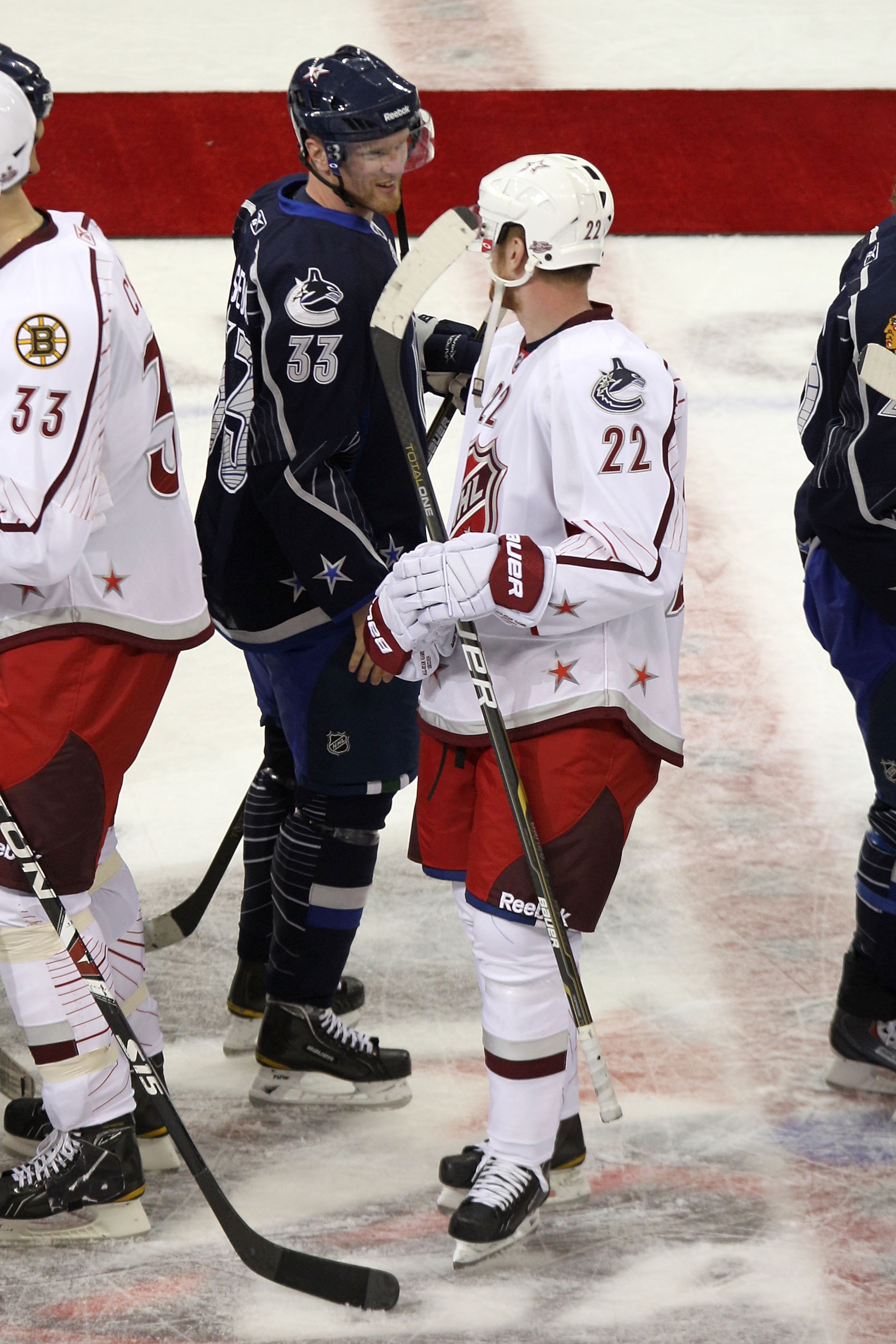 RALEIGH, NC - JANUARY 30:  Daniel Sedin #22 of the Vancouver Canucks and Team Staal talks to is brother Henrik Sedin #33 of the Vancouver Canucks and Team Lidstrom after Team Lidstrom defeated Team Staal 11 to 10 in the 58th NHL All-Star Game at RBC Cente