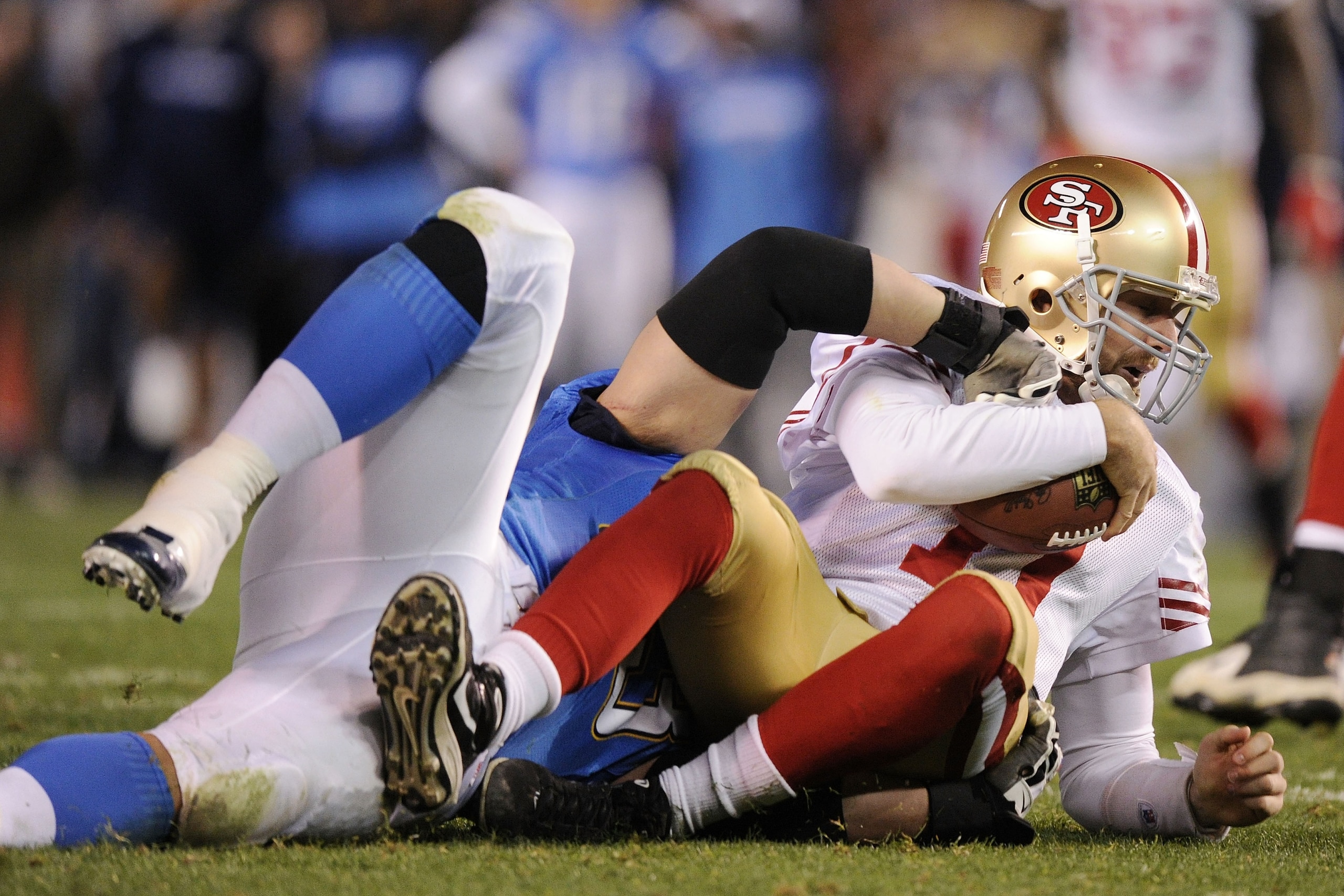 SAN DIEGO, CA - DECEMBER 16:  Quarterback Alex Smith #11 of the San Francisco 49ers is sacked by defensive end Luis Castillo #93 of the San Diego Chargers in the second quarter at Qualcomm Stadium on December 16, 2010 in San Diego, California.  (Photo by