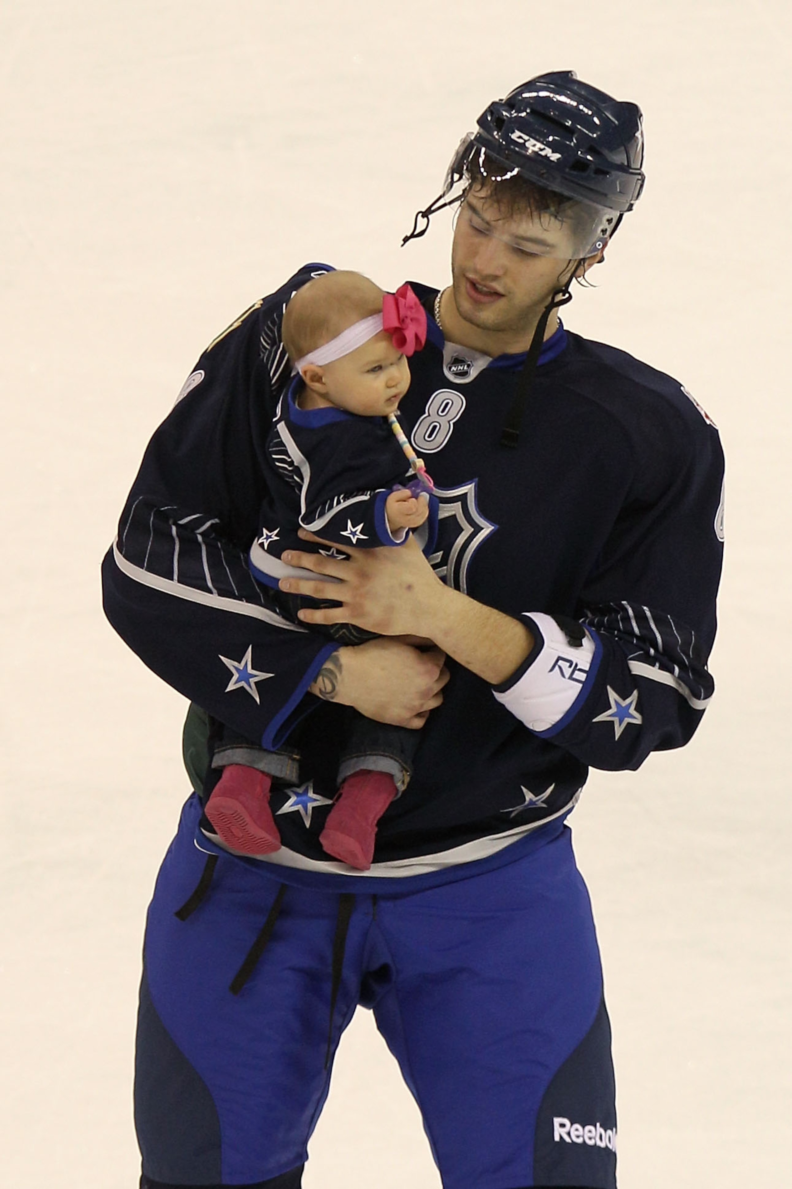 RALEIGH, NC - JANUARY 30:  Brent Burns #8 of the Minnesota Wild and Team Lidstrom holds his daughter Peyton after they defeated Team Staal 11 to 10 in the 58th NHL All-Star Game at RBC Center on January 30, 2011 in Raleigh, North Carolina.  (Photo by Bruc
