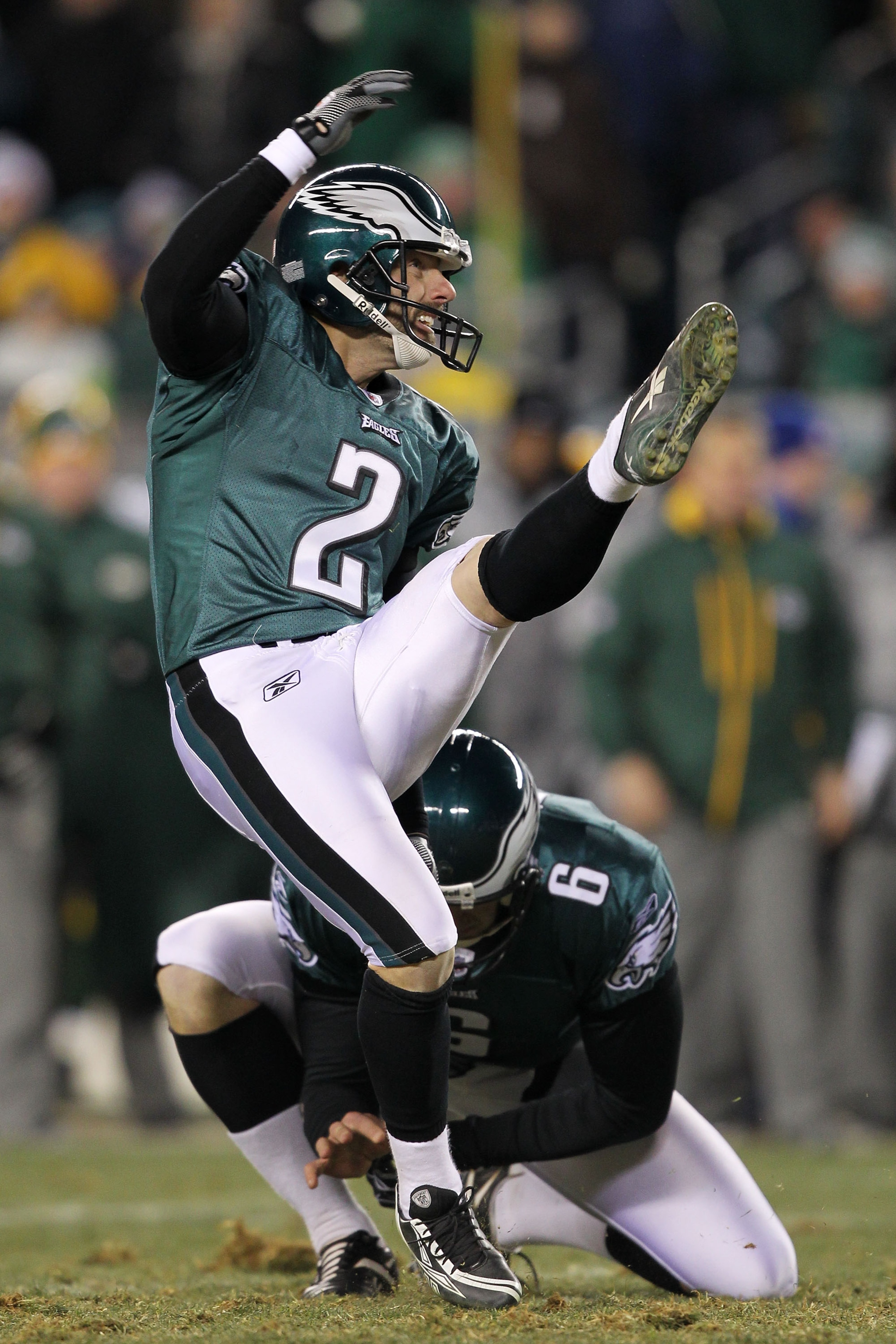 PHILADELPHIA, PA - JANUARY 09:  David Akers #2 kicks as Sav Rocca #6 of the Philadelphia Eagles holds against the Green Bay Packers during the 2011 NFC wild card playoff game at Lincoln Financial Field on January 9, 2011 in Philadelphia, Pennsylvania.  (P
