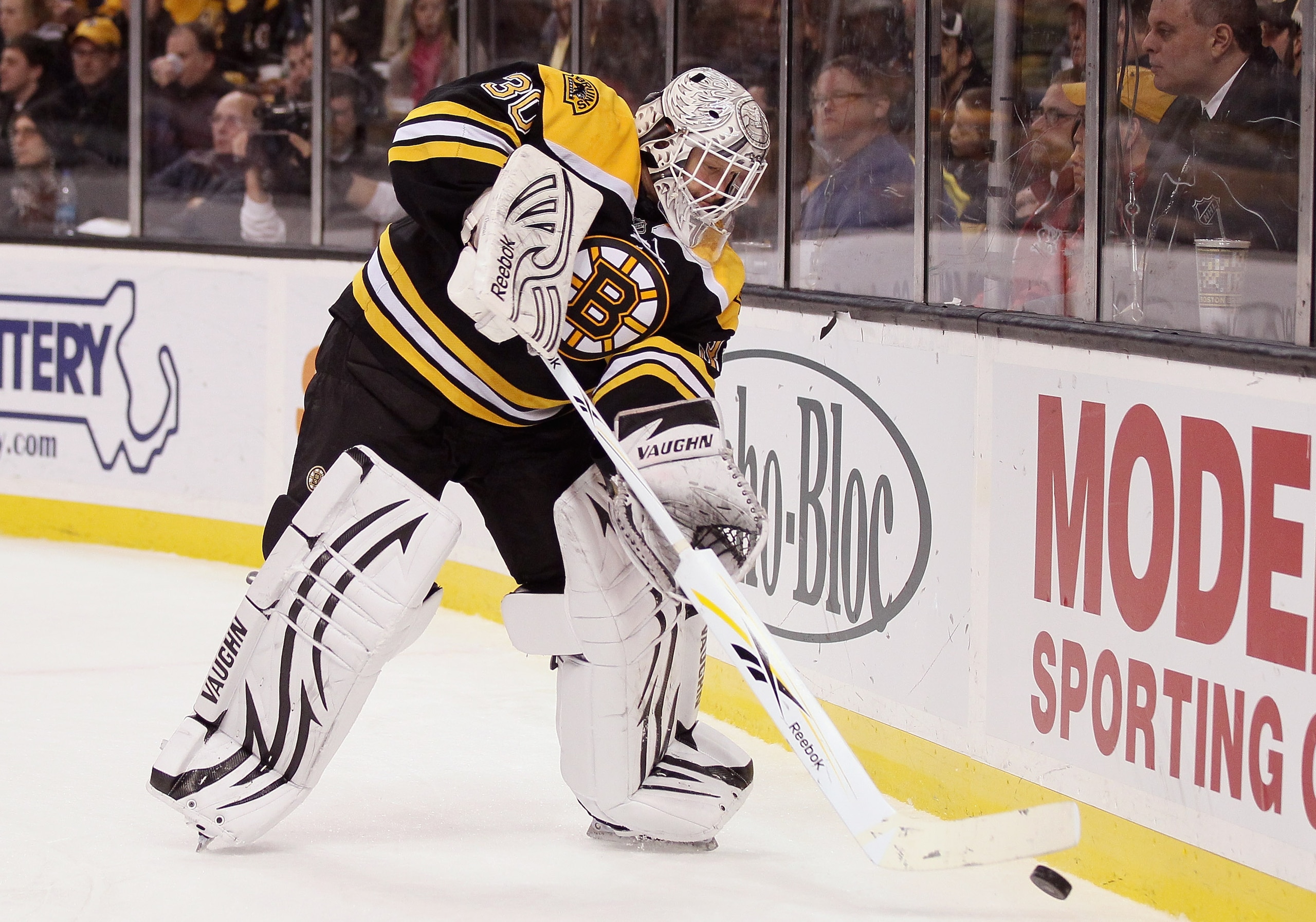 BOSTON, MA - JANUARY 26:  Tim Thomas #30 of the Boston Bruins clears the puck in the second period against Florida Panthers on January 26, 2011 at the TD Garden in Boston, Massachusetts.  (Photo by Elsa/Getty Images)