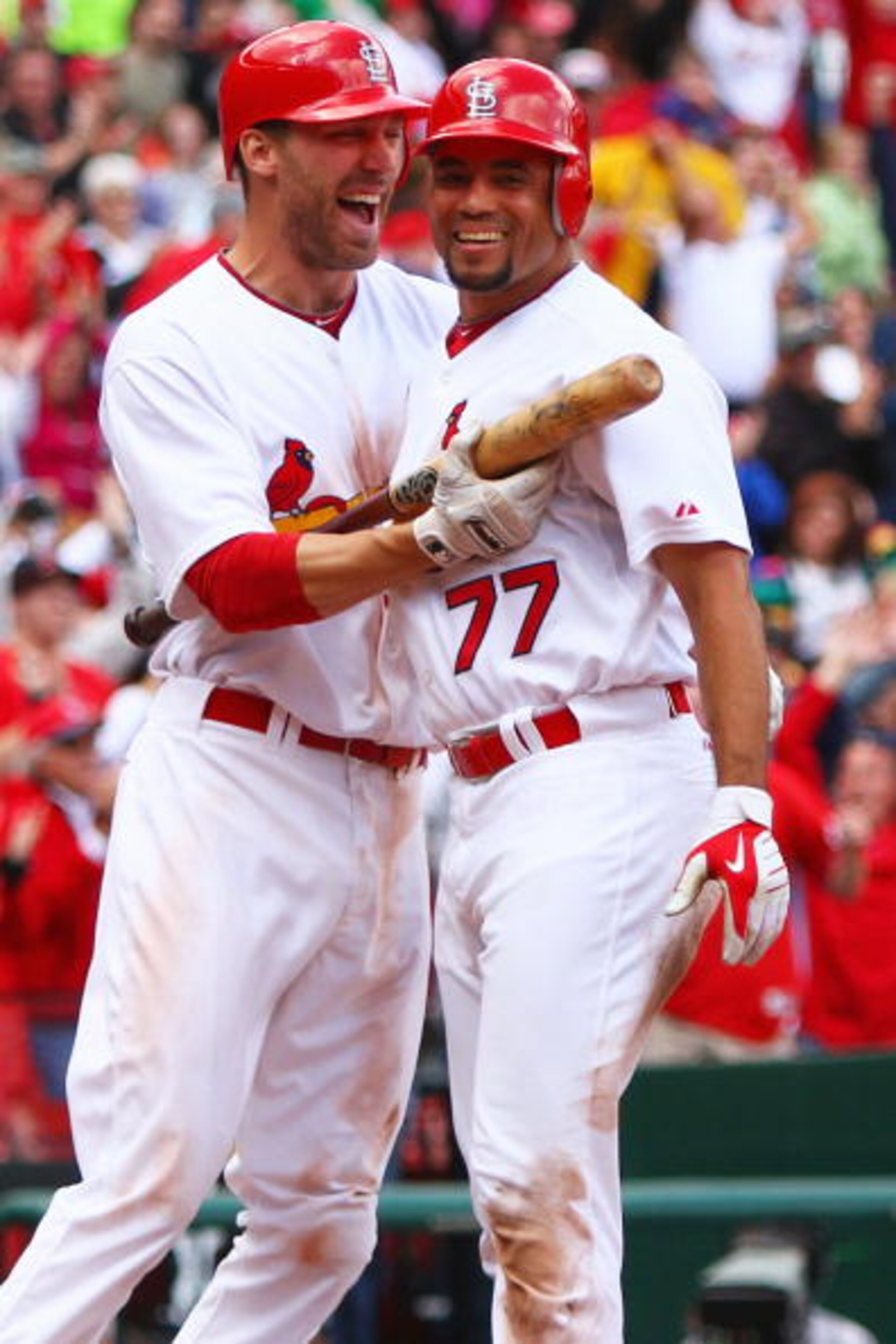ST. LOUIS - OCTOBER 2: Joe Mather #22 and Pedro Feliz #77 both of the St. Louis Cardinals celebrate Feliz's game-winning run against the Colorado Rockies at Busch Stadium on October 2, 2010 in St. Louis, Missouri.  The Cardinals beat the Rockies 1-0 in 11