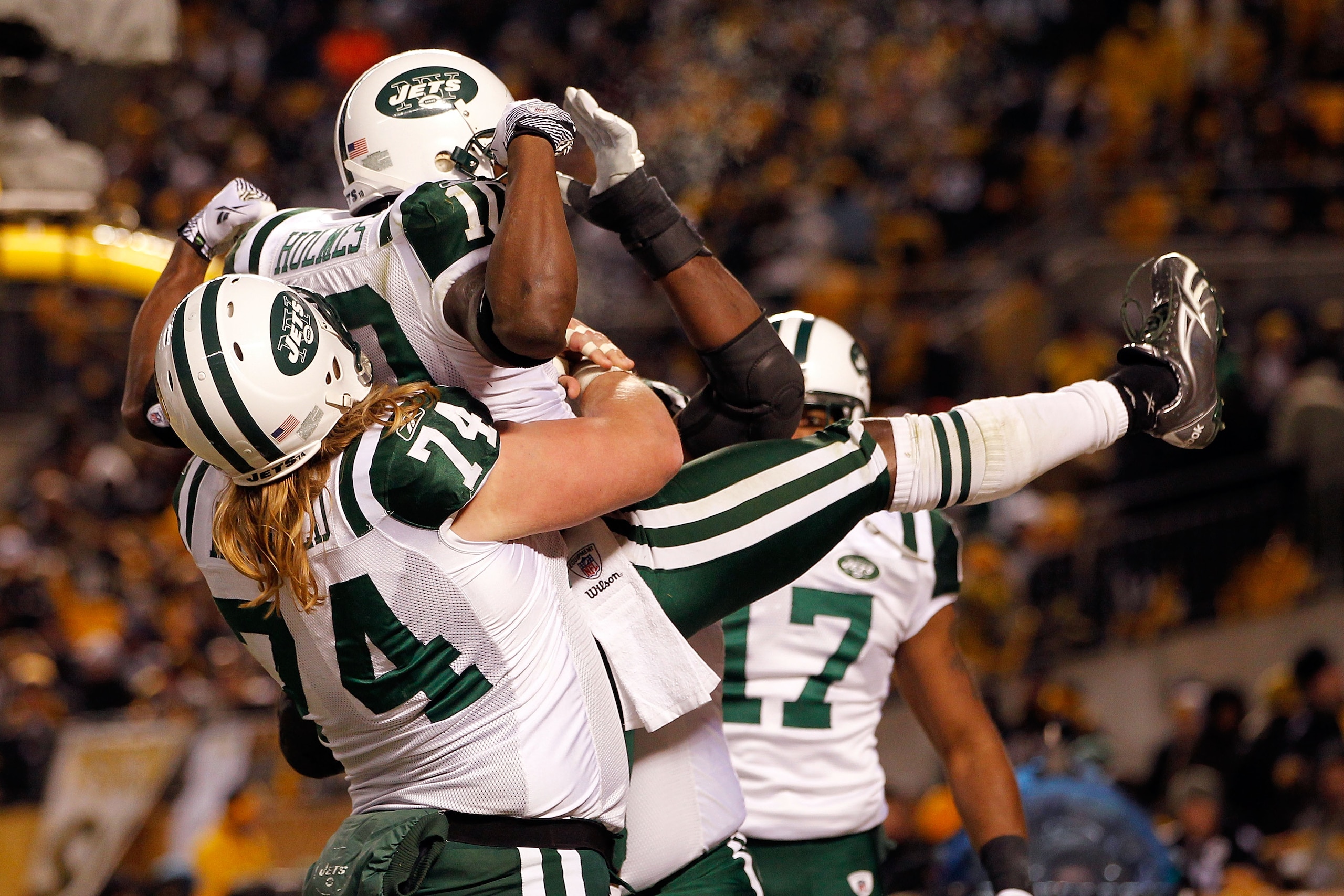 PITTSBURGH, PA - JANUARY 23:  Santonio Holmes #10, Braylon Edwards #17 and Nick Mangold #74 of the New York Jets celebrate after Holmes scored a third quarter touchdown against the Pittsburgh Steelers during the 2011 AFC Championship game at Heinz Field o