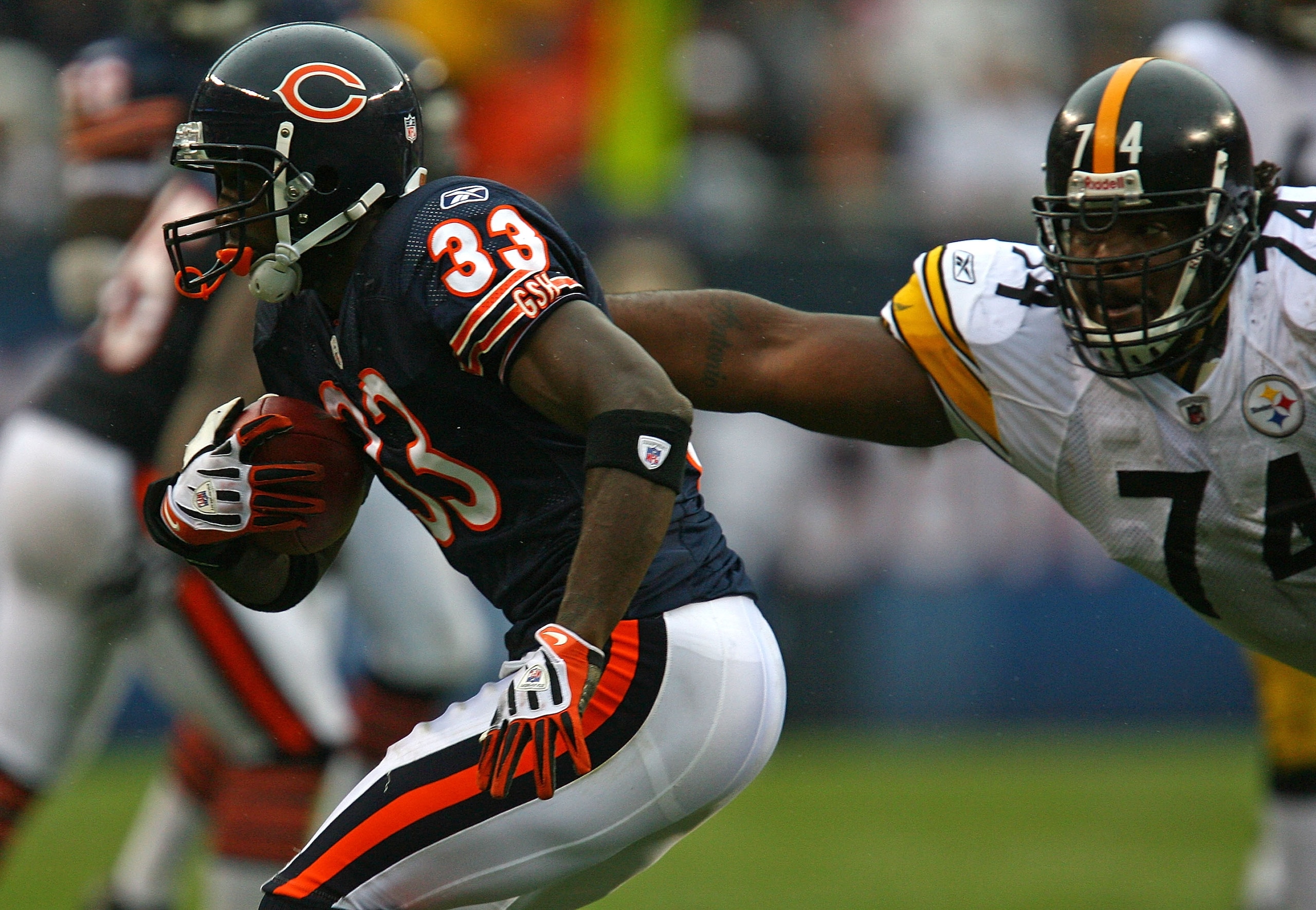 CHICAGO - SEPTEMBER 20: Charles Tillman #33 of the Chicago Bears avoids a tackle by Willie Colon #74 of the Pittsburgh Steelers after intercepting a pass on September 20, 2009 at Soldier Field in Chicago, Illinois. The Bears defeated the Steelers 17-14. (