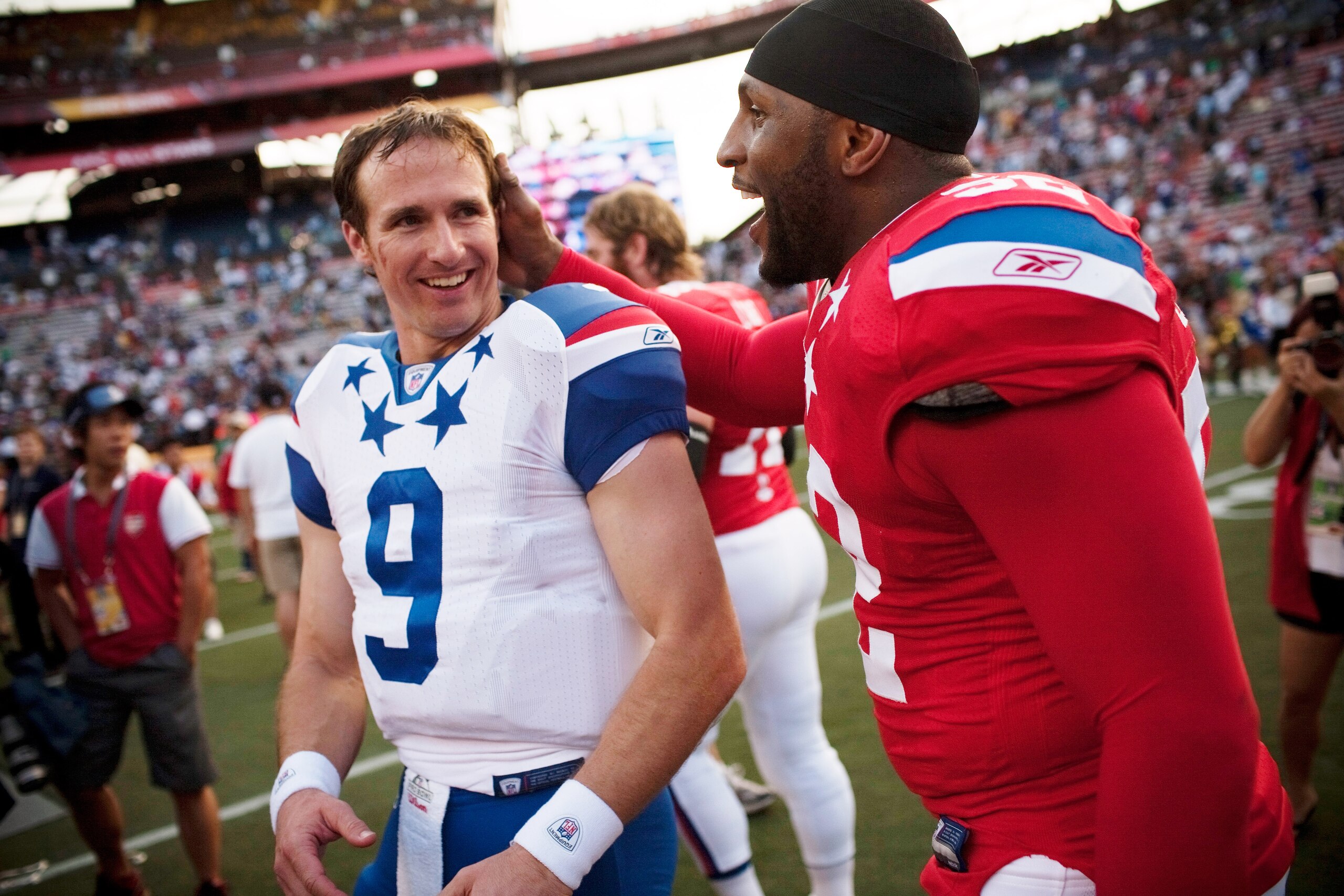 HONOLULU - JANUARY 30:  Drew Brees, #9 of the New Orleans Saints, shares a laugh with Devin McCourty, #32 of the New England Patriots, after the 2011 NFL Pro Bowl at Aloha Stadium on January 30, 2011 in Honolulu, Hawaii. NFC won 55-41 over the AFC. (Photo