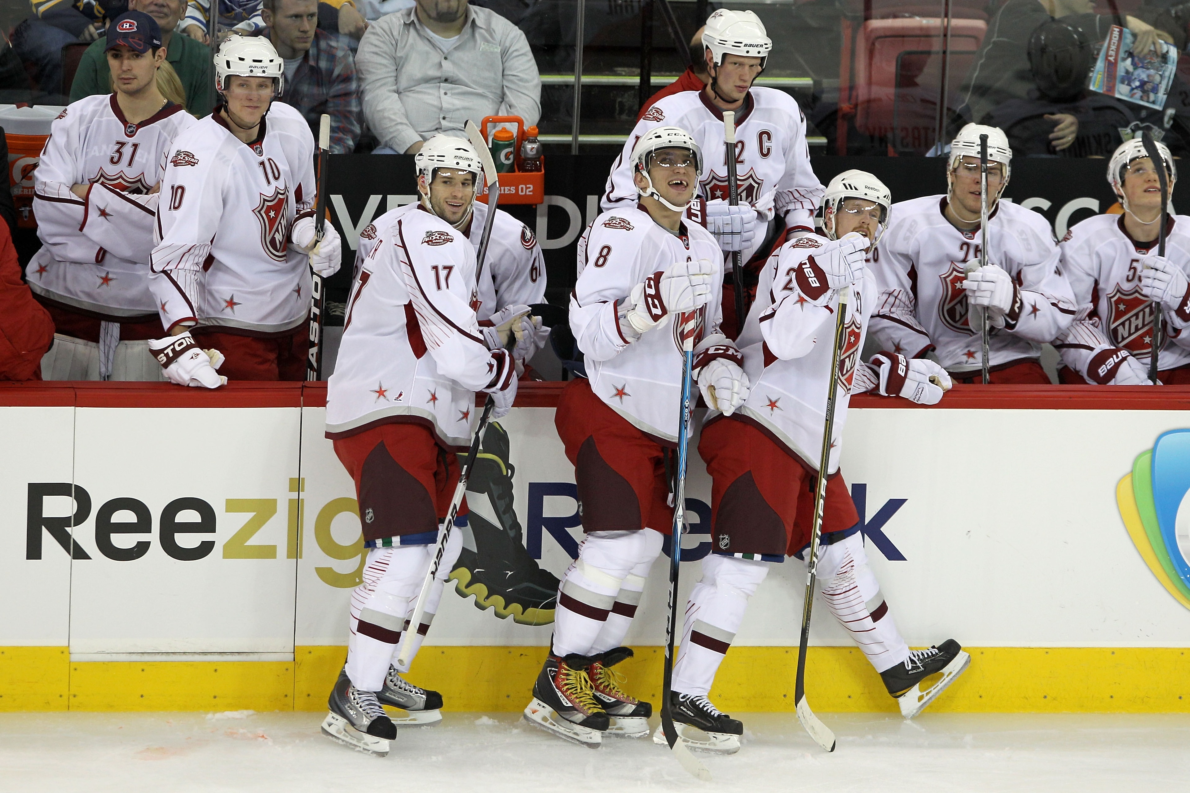 RALEIGH, NC - JANUARY 30:  Team Staal players Ryan Kesler #17 of the Vancouver Canucks, Alexander Ovechkin #8 of the Washington Capitals and Daniel Sedin #22 of the Vancouver Canucks reacts with their team in the third period against Team Lidstrom in the