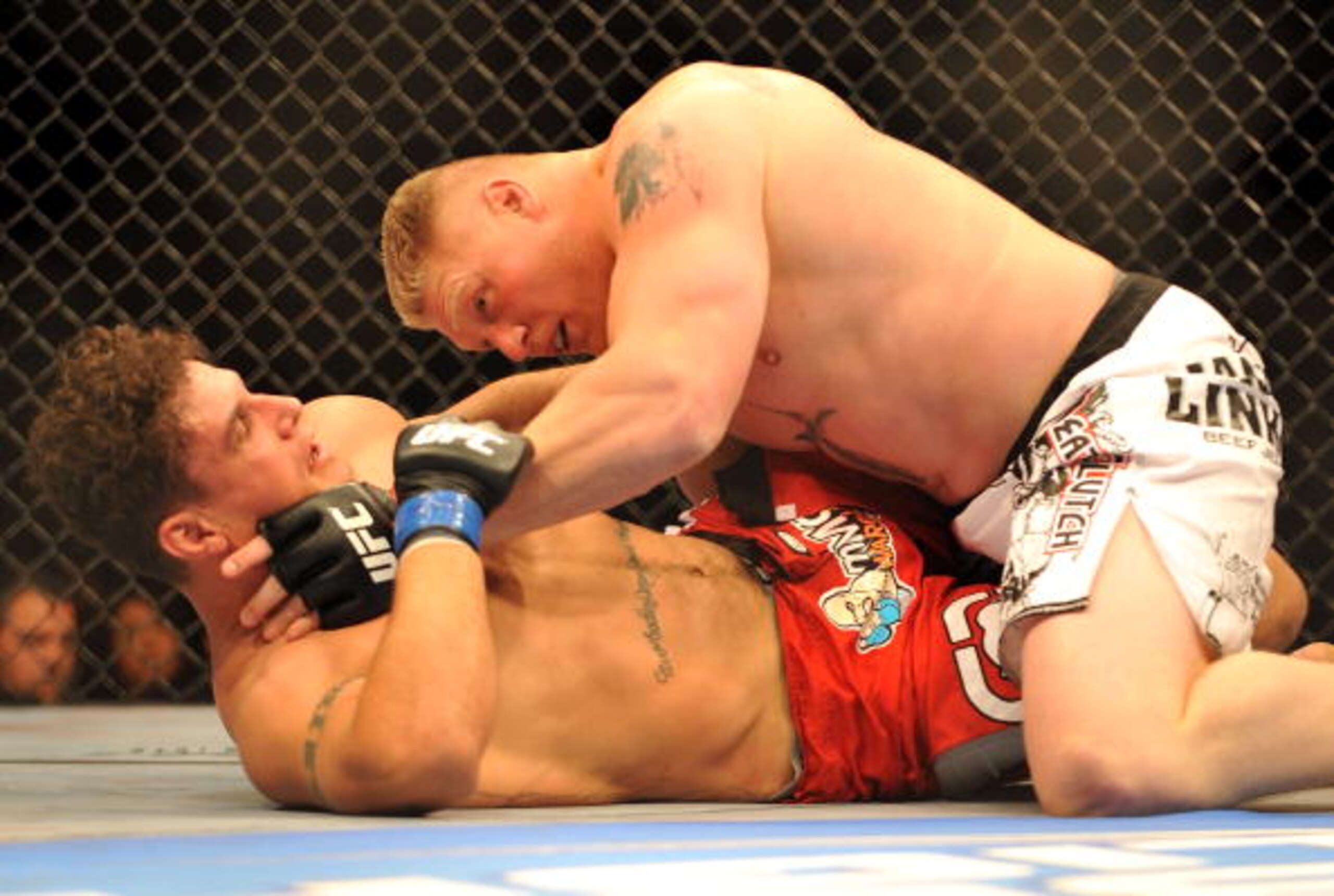 LAS VEGAS - JULY 11: Brock Lesnar holds down Frank Mir during their heavyweight title bout during UFC 100 on July 11, 2009 in Las Vegas, Nevada. (Photo by Jon Kopaloff/Getty Images) LAS VEGAS - JULY 11: Brock Lesnar holds down Frank Mir during their heavyweight title bout during UFC 100 on July 11, 2009 in Las Vegas, Nevada. (Photo by Jon Kopaloff/Getty Images)
