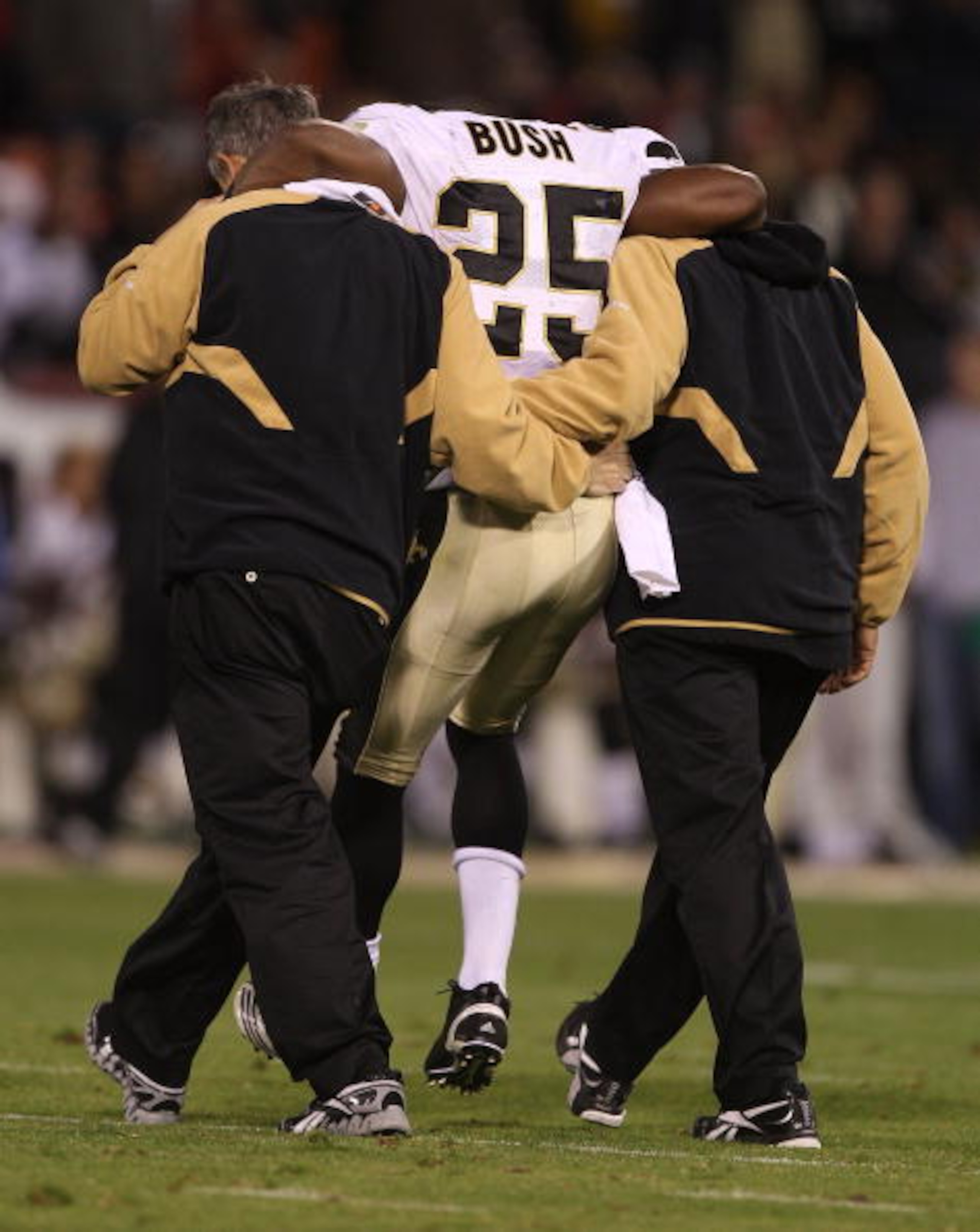 SAN FRANCISCO - SEPTEMBER 20:  Reggie Bush #25 of the New Orleans Saints is helped off the field after being injured against the San Francisco 49ers during an NFL game at Candlestick Park on September 20, 2010 in San Francisco, California.  (Photo by Jed
