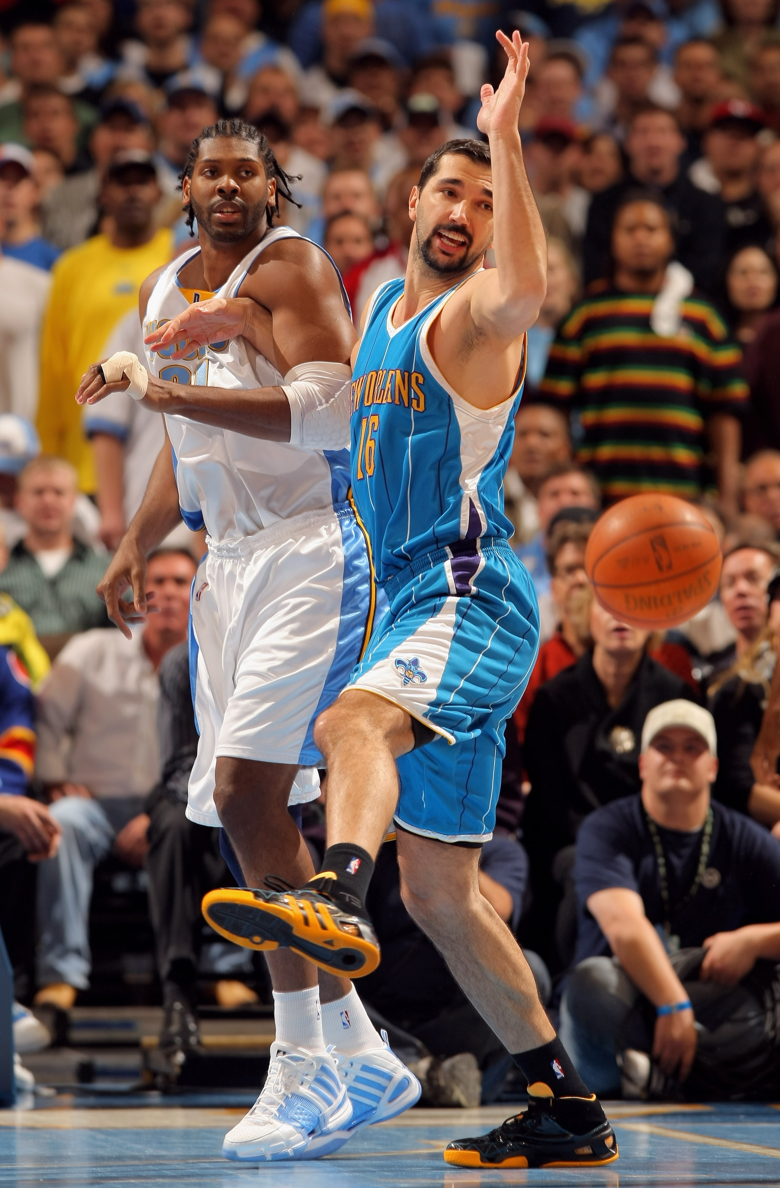 DENVER - APRIL 19: Peja Stojakovic #16 of the New Orleans Hornets and Nene #31 of the Denver Nuggets vie for a loose ball in Game One of the Western Conference Quarterfinals during the 2009 NBA Playoffs at Pepsi Center on April 19, 2009 in Denver, Colora DENVER - APRIL 19: Peja Stojakovic #16 of the New Orleans Hornets and Nene #31 of the Denver Nuggets vie for a loose ball in Game One of the Western Conference Quarterfinals during the 2009 NBA Playoffs at Pepsi Center on April 19, 2009 in Denver, Colora