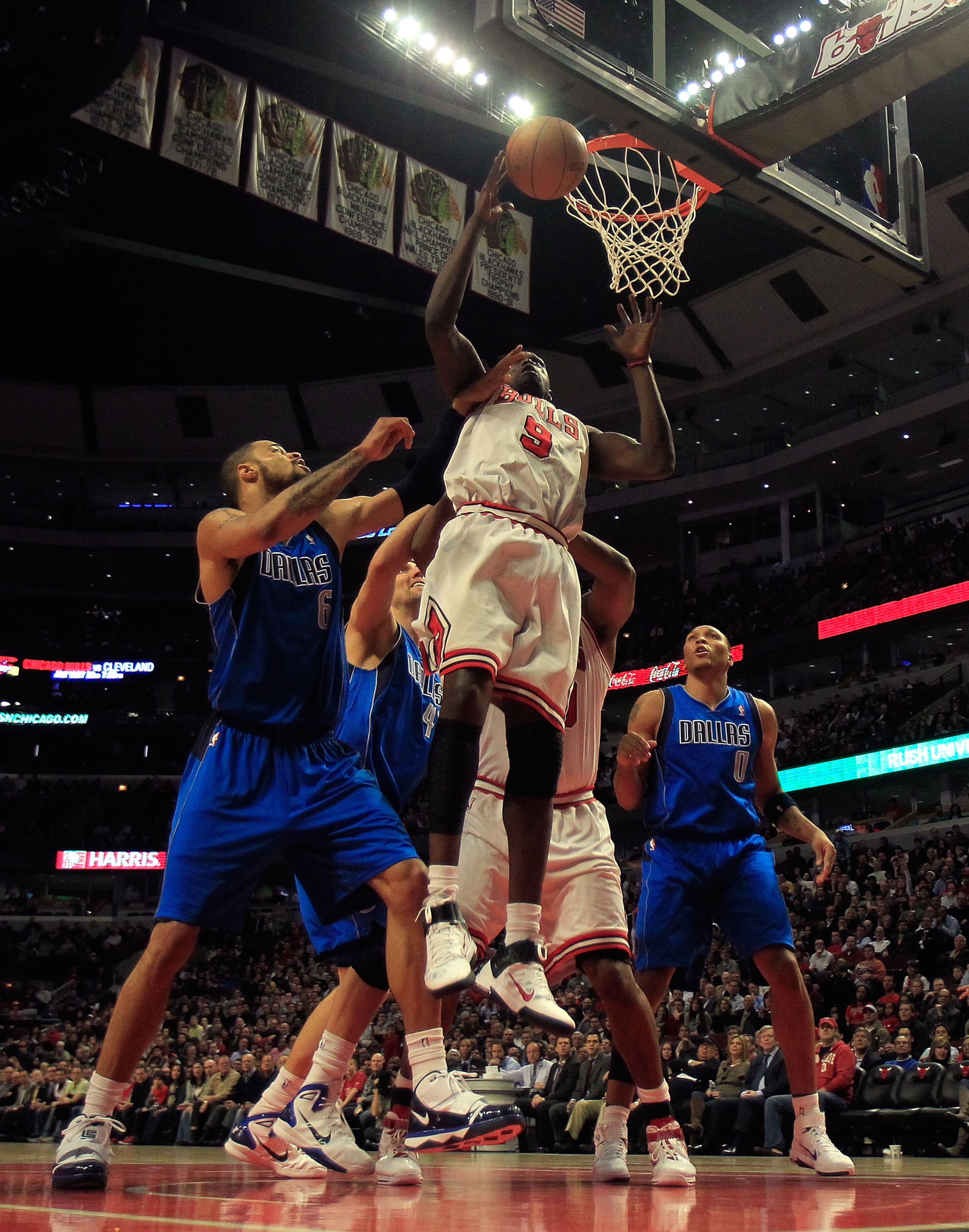 CHICAGO, IL - JANUARY 20: Loul Deng #9 of the Chicago Bulls goes up for a rebound over Tyson Chandler #6, Dirk Nowitzki #41 and Shawn Marion #0 of the Dallas Mavericks at the United Center on January 20, 2011 in Chicago, Illinois. The Bulls defeated the M CHICAGO, IL - JANUARY 20: Loul Deng #9 of the Chicago Bulls goes up for a rebound over Tyson Chandler #6, Dirk Nowitzki #41 and Shawn Marion #0 of the Dallas Mavericks at the United Center on January 20, 2011 in Chicago, Illinois. The Bulls defeated the M
