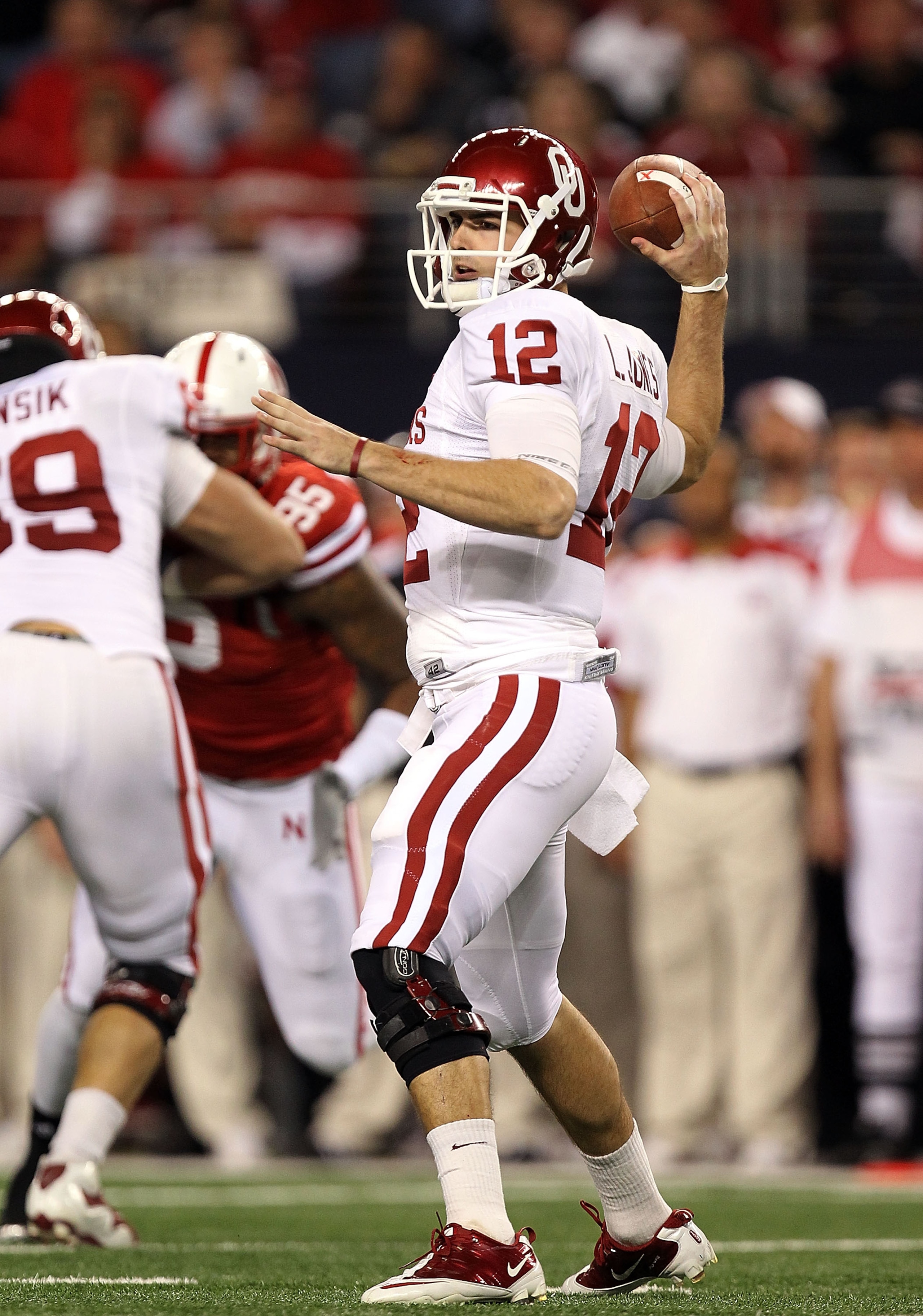 ARLINGTON, TX - DECEMBER 04:  Quarterback Landry Jones #12 of the Oklahoma Sooners drops back to pass against the Nebraska Cornhuskers during the Big 12 Championship at Cowboys Stadium on December 4, 2010 in Arlington, Texas.  (Photo by Ronald Martinez/Ge