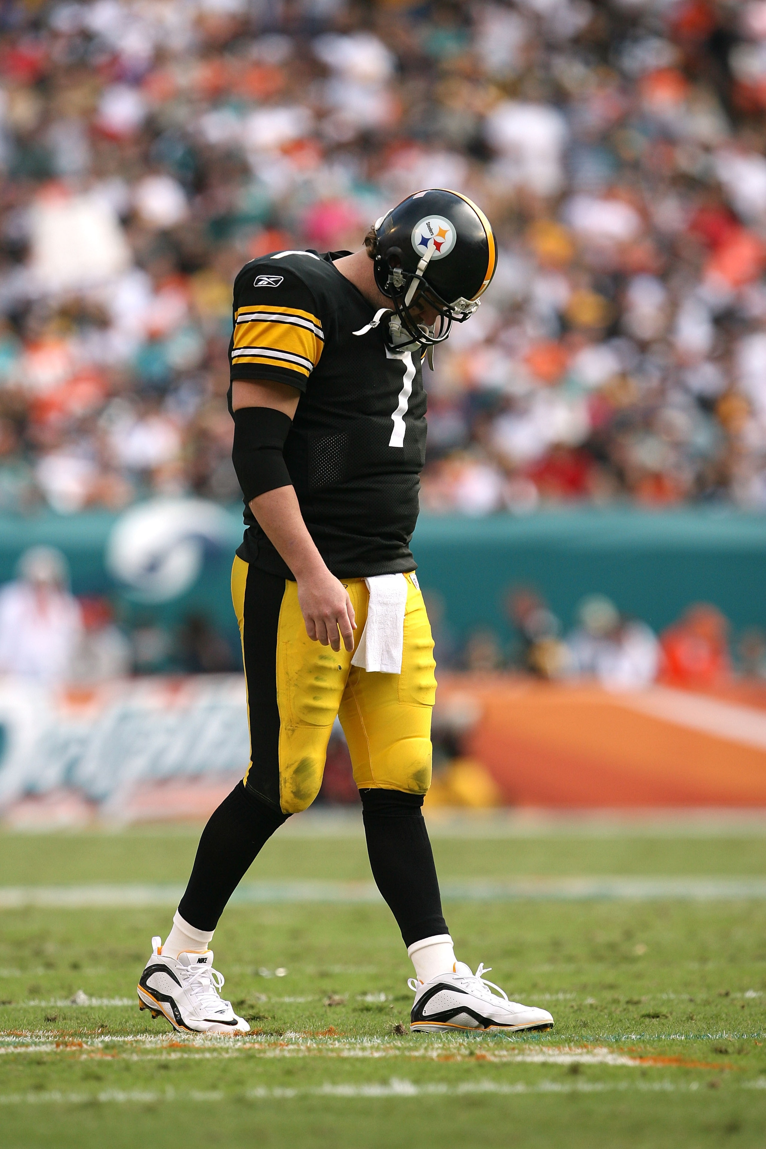 MIAMI - JANUARY 03:  Quarterback Ben Roethlisberger #7 of the Pittsburgh Steelers walks back to the huddle after injuring his shoulder in the fourth quarter against the Miami Dolphins at Land Shark Stadium on January 3, 2010 in Miami, Florida. The Steeler