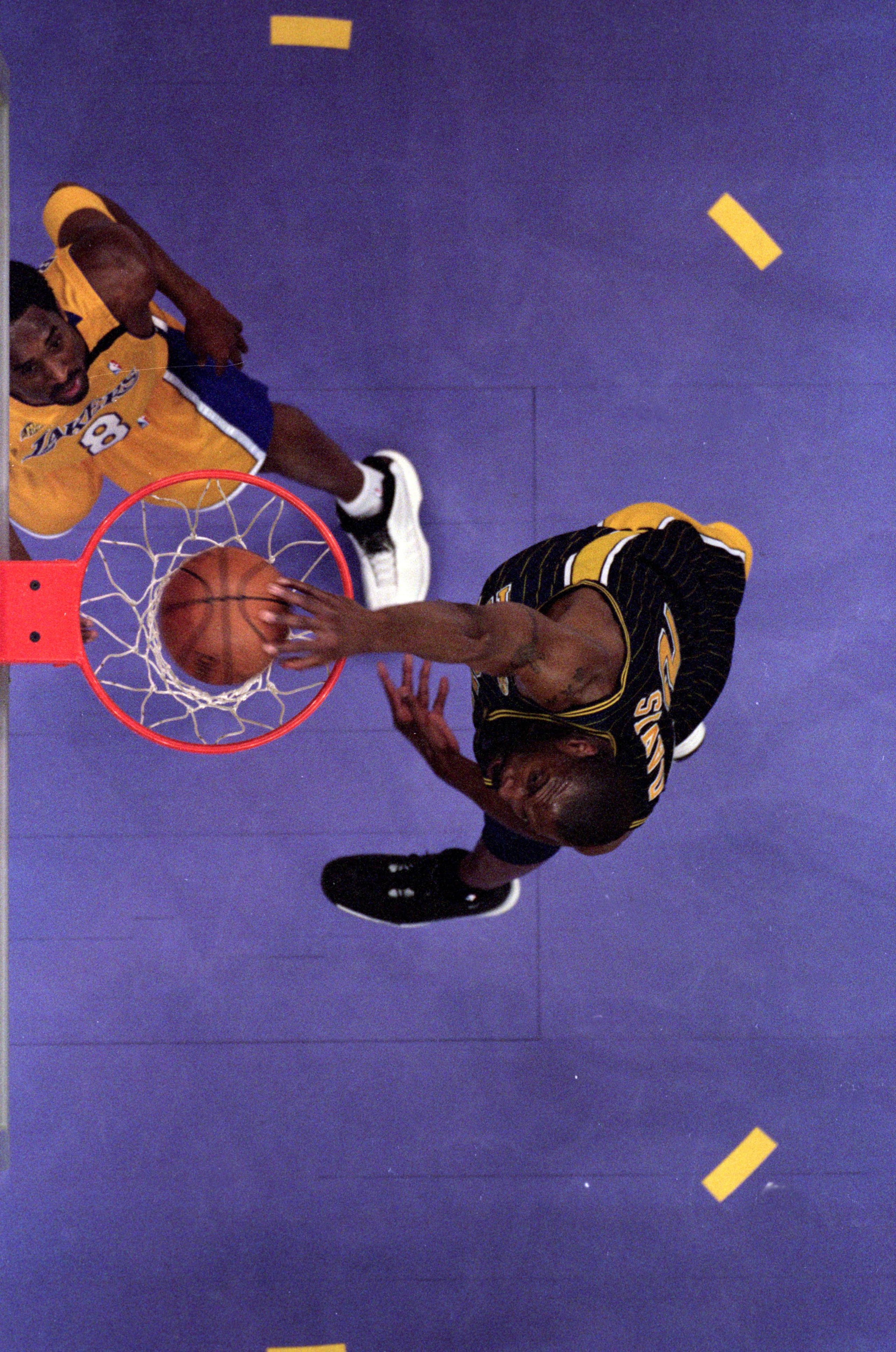 19 Jun 2000: An over head view of Dale Davis #32 of the Indiana Pacers making a slam dunk as he is guarded by Kobe Bryant #8 of the Los Angeles Lakers during the NBA Finals Game 6 at the Staples Center in Los Angeles, California.  The Lakers defeated the 