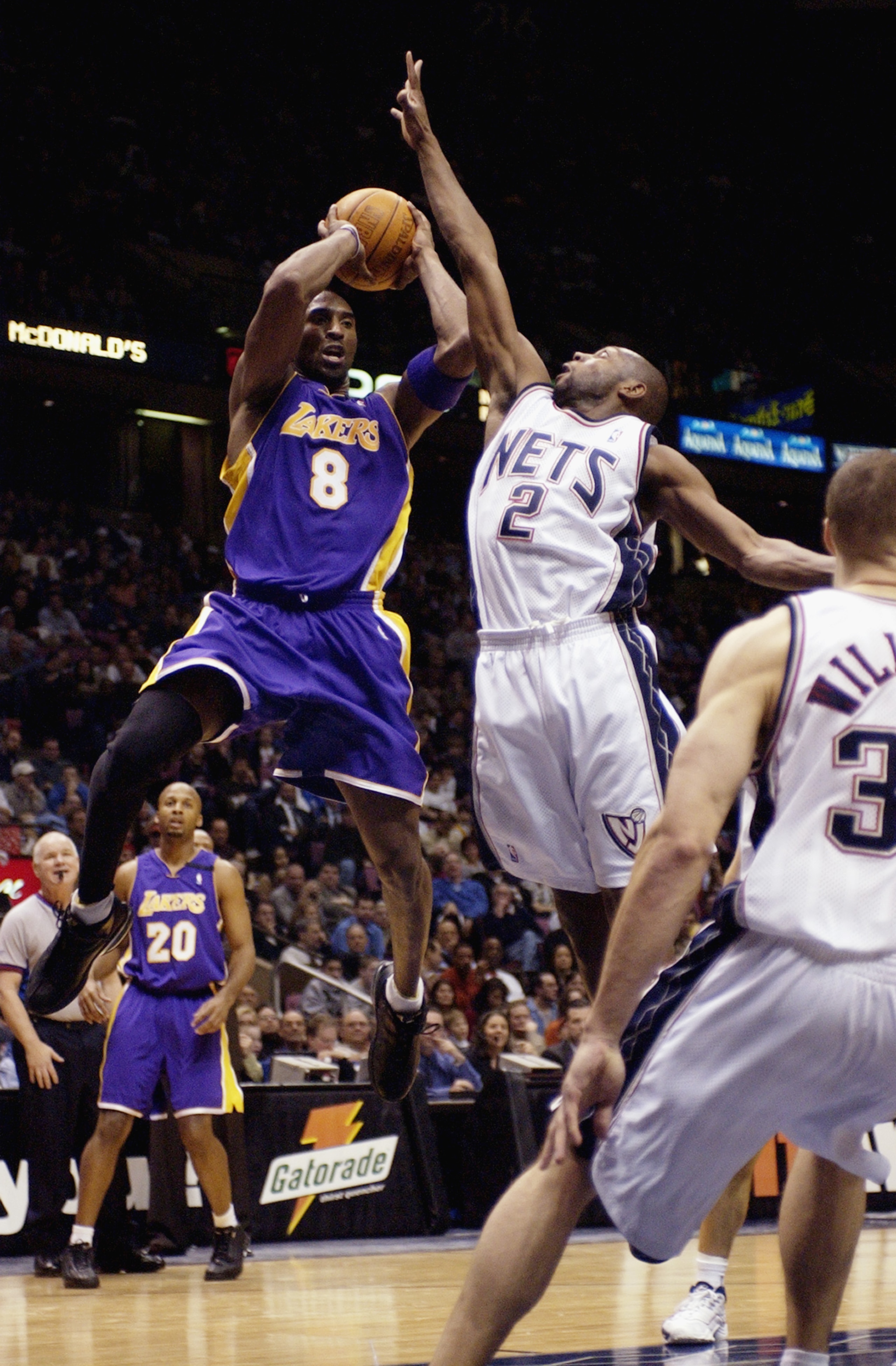 EAST RUTHERFORD, NJ - DECEMBER 19:  Kobe Bryant #8 of the Los Angeles Lakers looks to make a pass against Anthony Johnson #2 of the New Jersey Nets during the NBA game at Continental Airlines Arena on December 19, 2002 in East Rutherford, New Jersey.  The