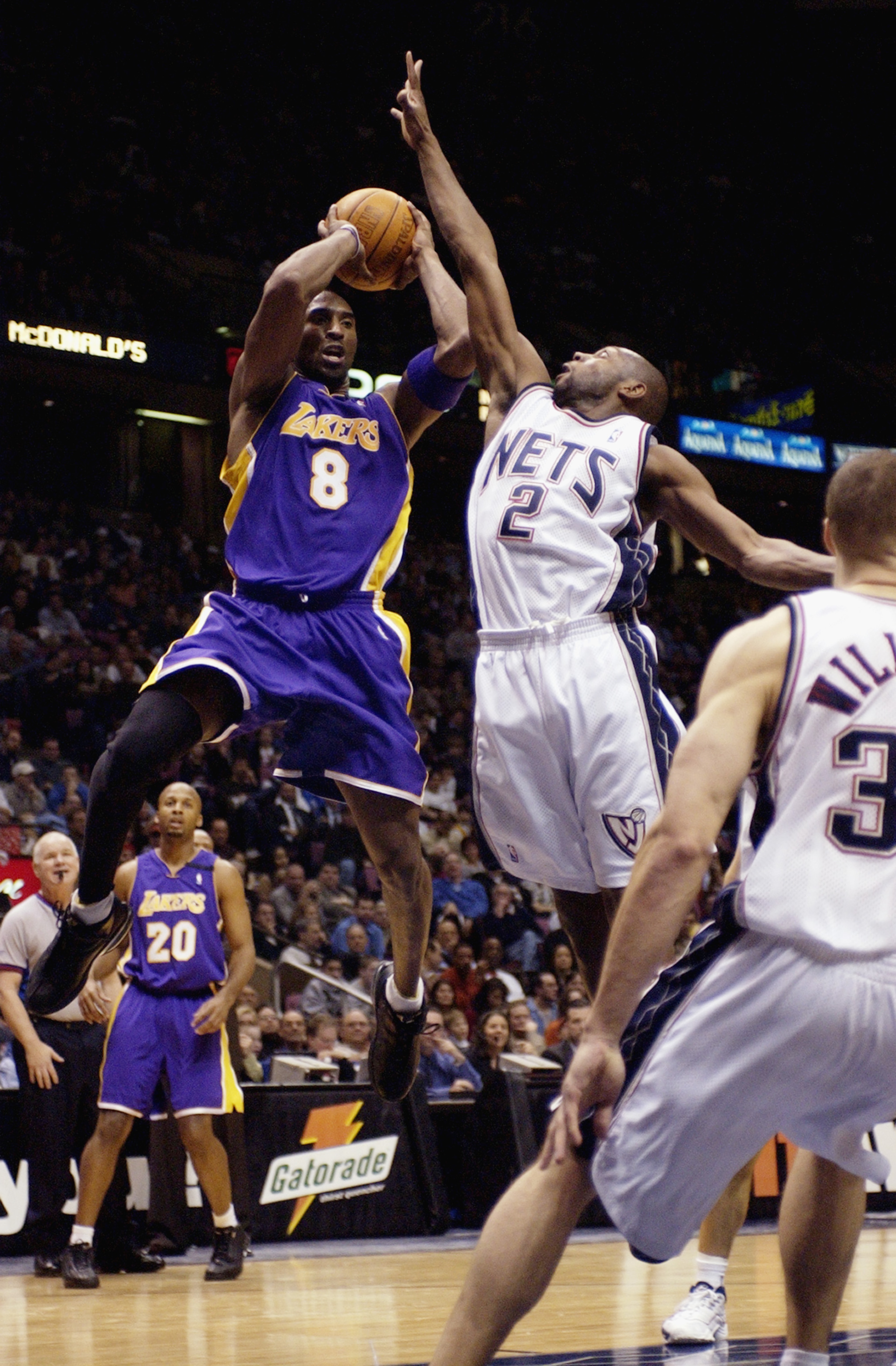EAST RUTHERFORD, NJ - DECEMBER 19:  Kobe Bryant #8 of the Los Angeles Lakers looks to make a pass against Anthony Johnson #2 of the New Jersey Nets during the NBA game at Continental Airlines Arena on December 19, 2002 in East Rutherford, New Jersey.  The