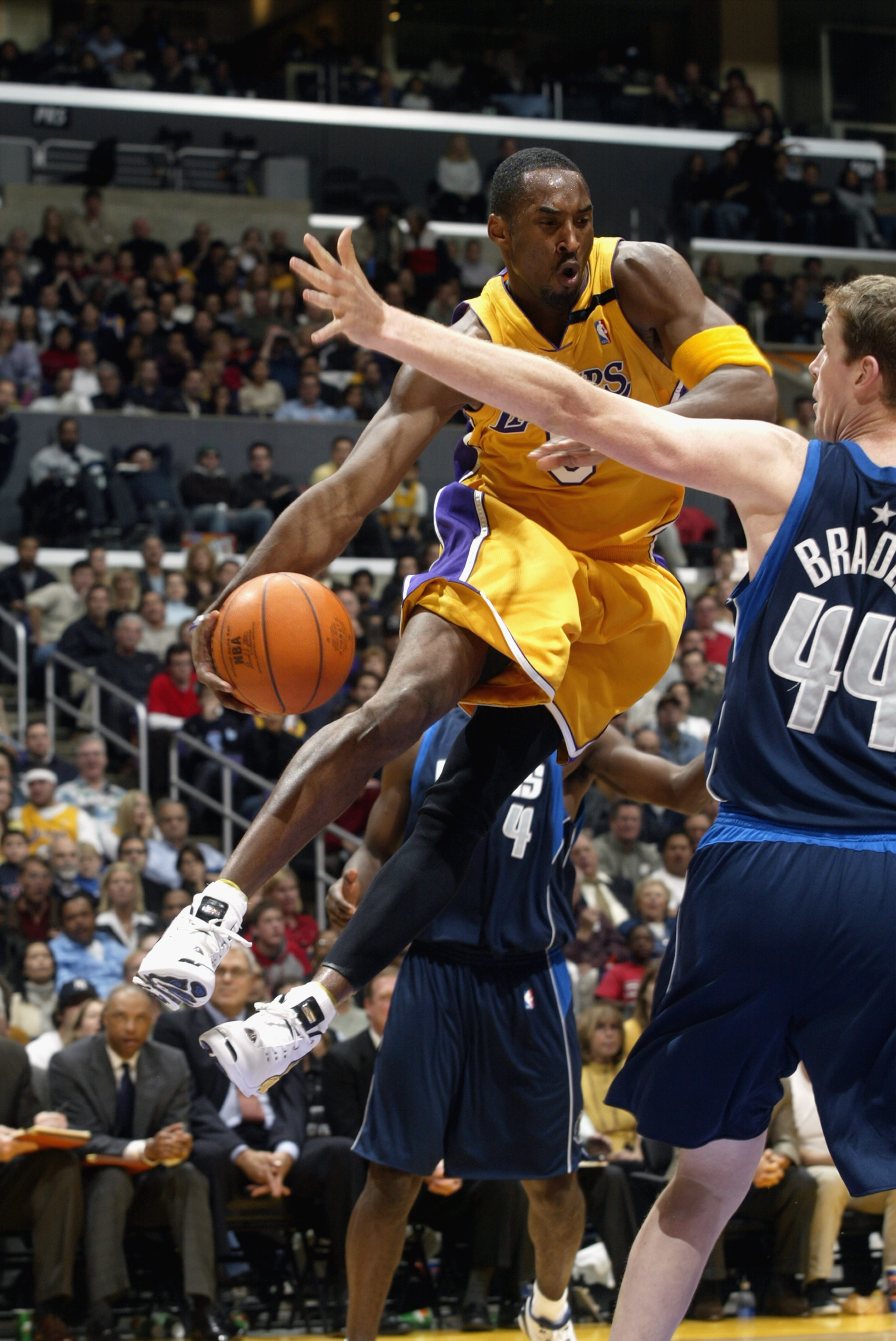 LOS ANGELES  - DECEMBER 6:   Kobe Bryant #8 of the Los Angeles Lakers looks to pass around Sean Bradley #44 of the Dallas Mavericks during the NBA game at the Staples Center on December 6, 2002 in Los Angeles, California.  The Lakers came back from a 30-p