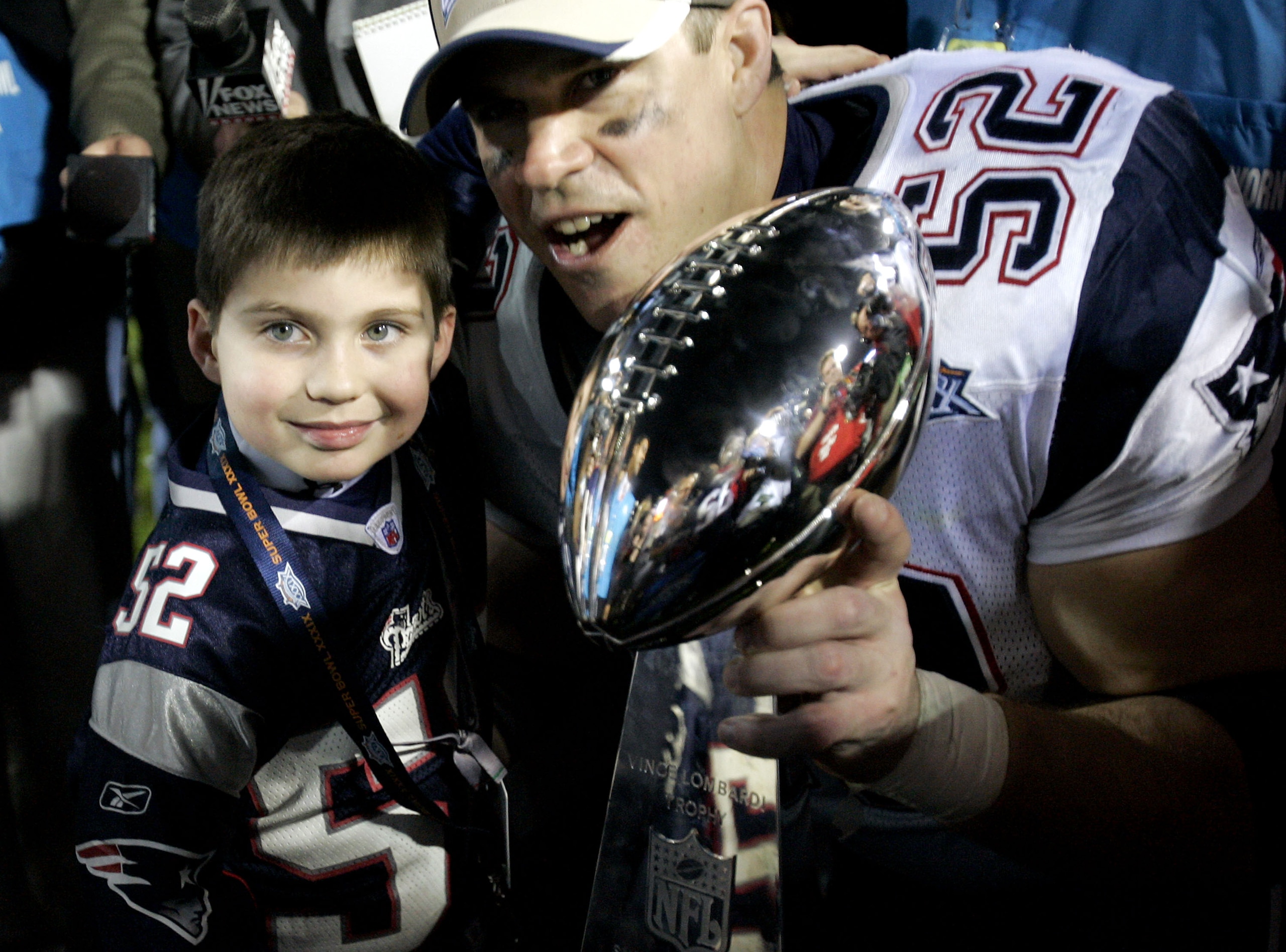 JACKSONVILLE, FL - FEBRUARY 06:  Ted Johnson #52 of the New England Patriots poses with his son after defeating the Philadelphia Eagles in Super Bowl XXXIX at Alltel Stadium on February 6, 2005 in Jacksonville, Florida.  The Patriots defeated the Eagles 2