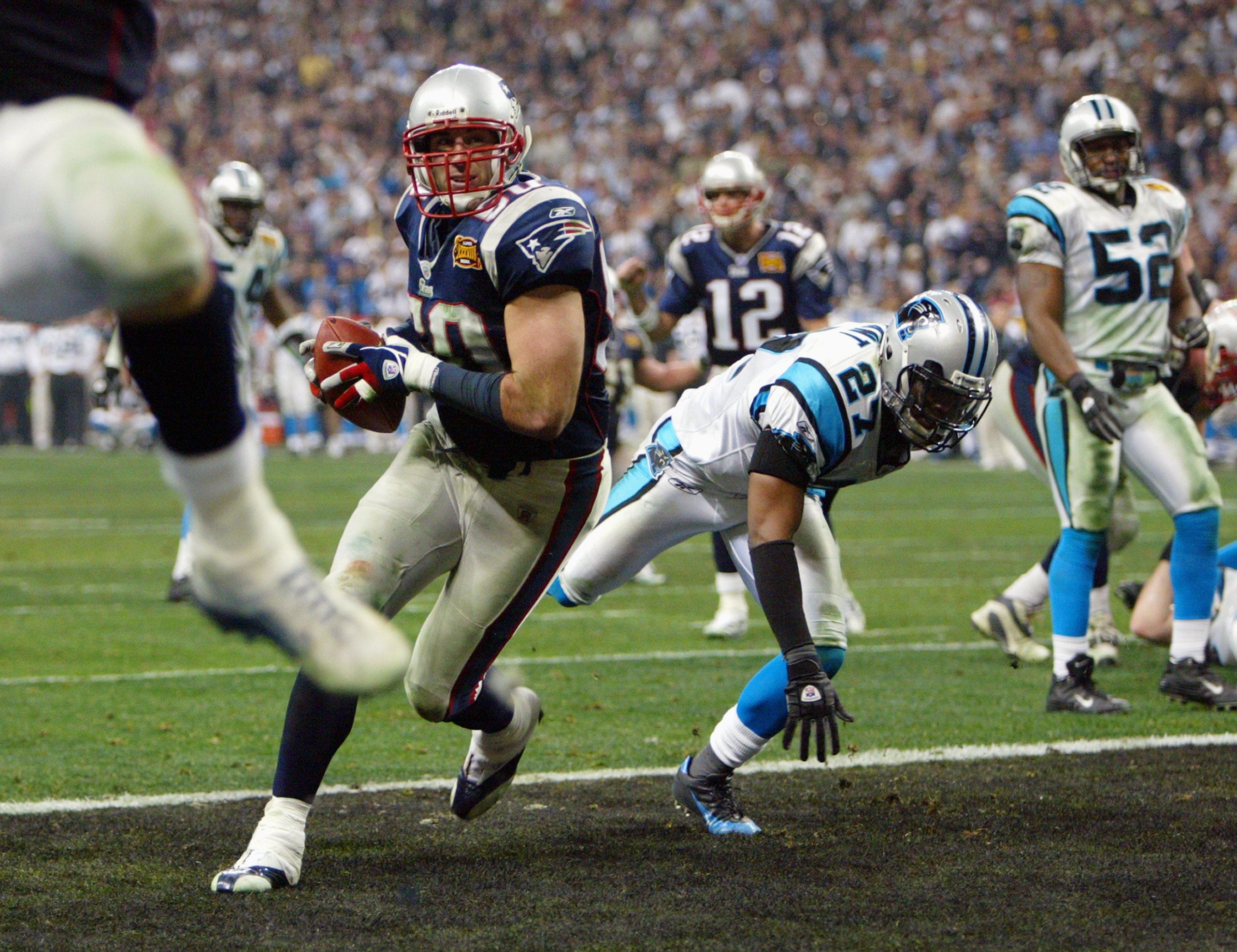 HOUSTON - FEBRUARY 1:  Mike Vrabel#50 of the New England Patriots scores a touchdown against the Carolina Panthers during Super Bowl XXXVIII at Reliant Stadium on February 1, 2004 in Houston, Texas.  The Patriots defeated the Panthers 32-29.  (Photo by An