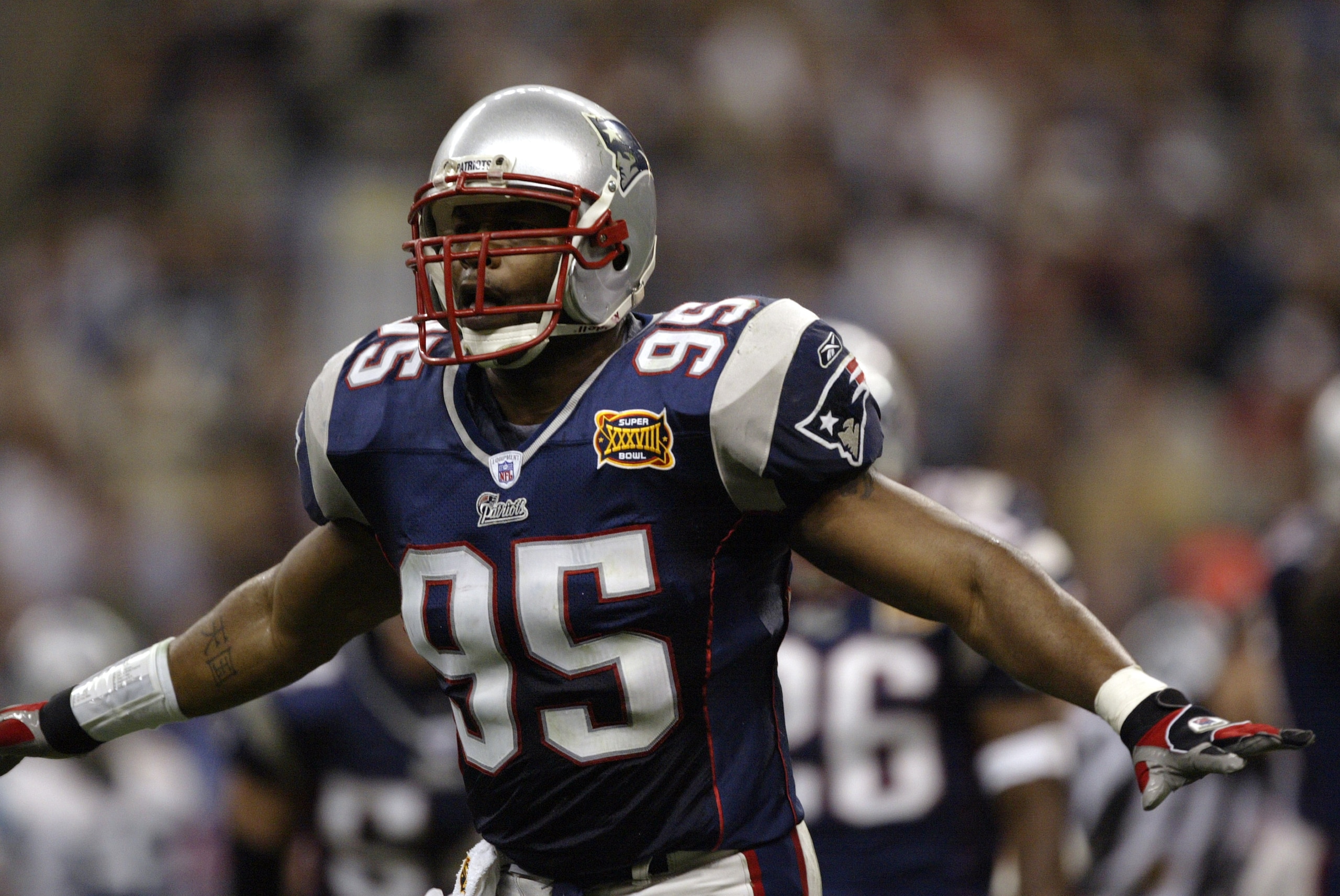 HOUSTON - FEBRUARY 1:  Linebacker Roman Phifer #95 of the New England Patriots celebrates during Super Bowl XXXVIII against the Carolina Panthers at Reliant Stadium on February 1, 2004 in Houston, Texas.  The Patriots defeated the Panthers 32-29.  (Photo