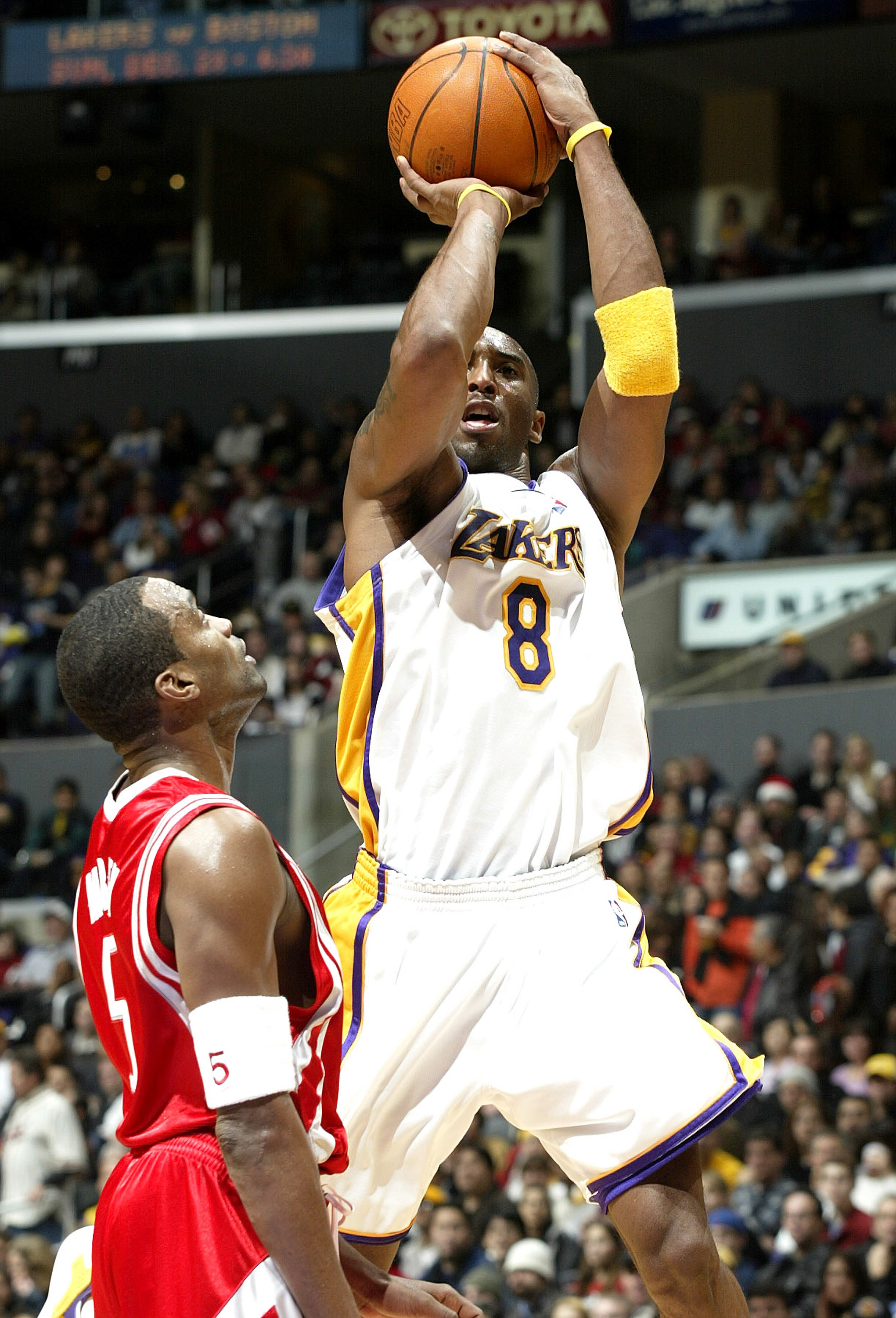 LOS ANGELES - DECEMBER 25:  Kobe Bryant #8 of the Los Angeles Lakers puts a shot up over Cuttino Mobley #5 of the Houston Rockets on December 25, 2003 at the Staples Center in Los Angeles, California.  NOTE TO USER: User expressly acknowledges and agrees