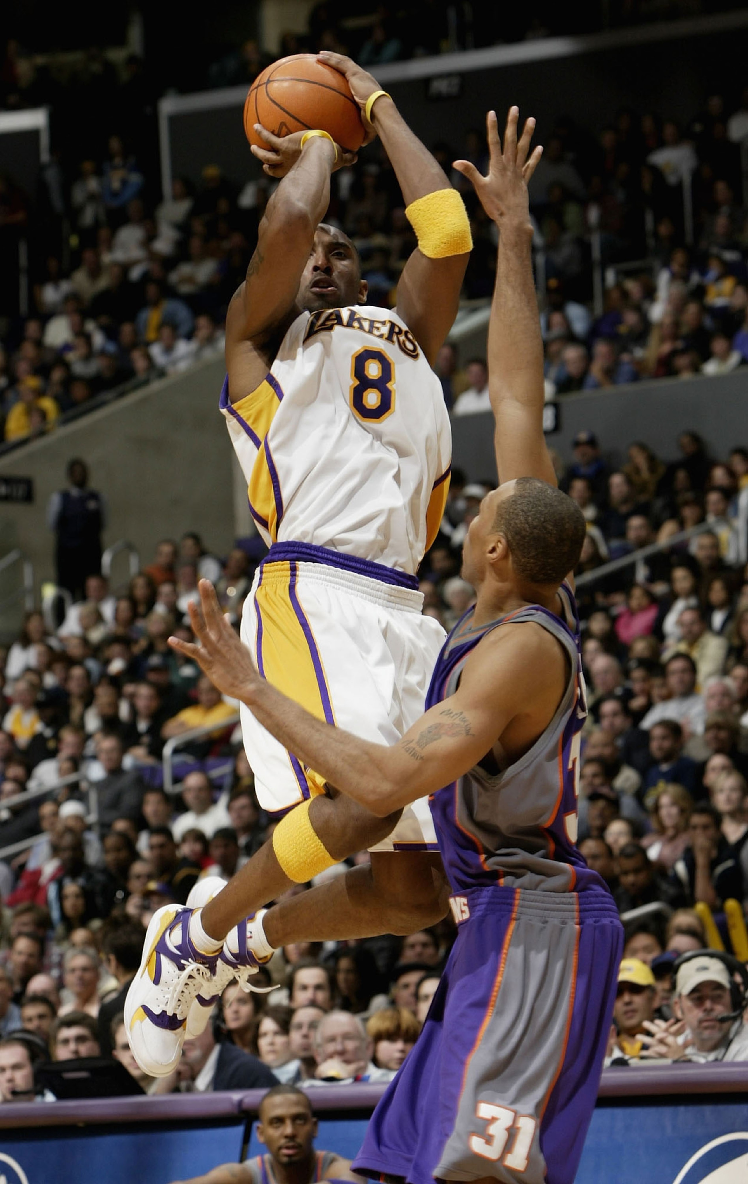 LOS ANGELES - DECEMBER 21:  Kobe Bryant #8 of the Los Angeles Lakers takes a shot over Shawn Marion #31 of the Phoenix Suns on December 21, 2003 at Staples Center in Los Angeles, California.  The Lakers won 107-101.   NOTE TO USER: User expressly acknowle