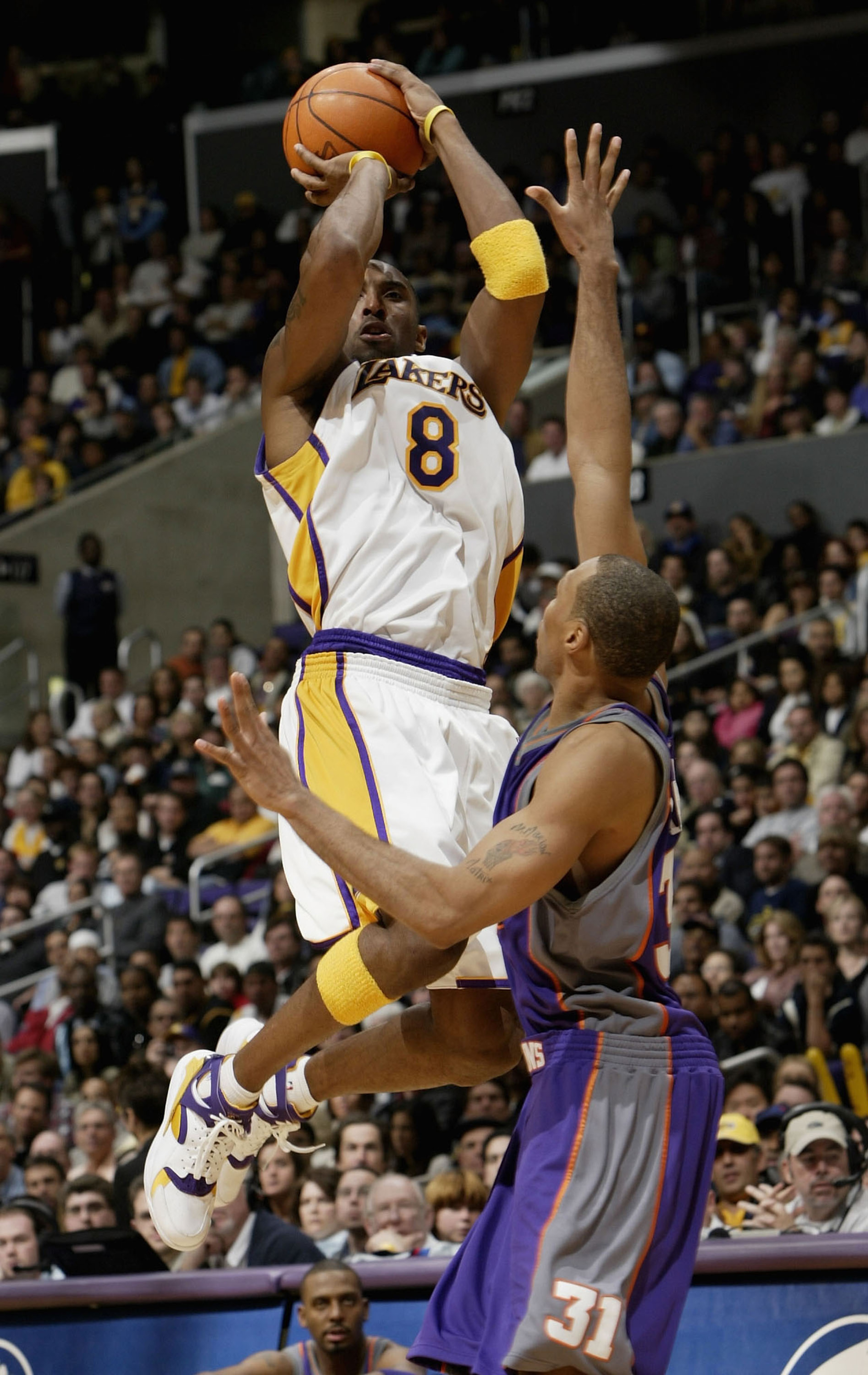 LOS ANGELES - DECEMBER 21:  Kobe Bryant #8 of the Los Angeles Lakers takes a shot over Shawn Marion #31 of the Phoenix Suns on December 21, 2003 at Staples Center in Los Angeles, California.  The Lakers won 107-101.   NOTE TO USER: User expressly acknowle